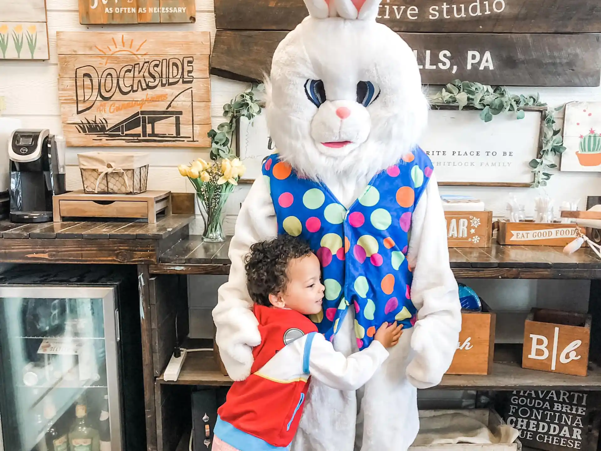 a child hugging a person in a rabbit garment