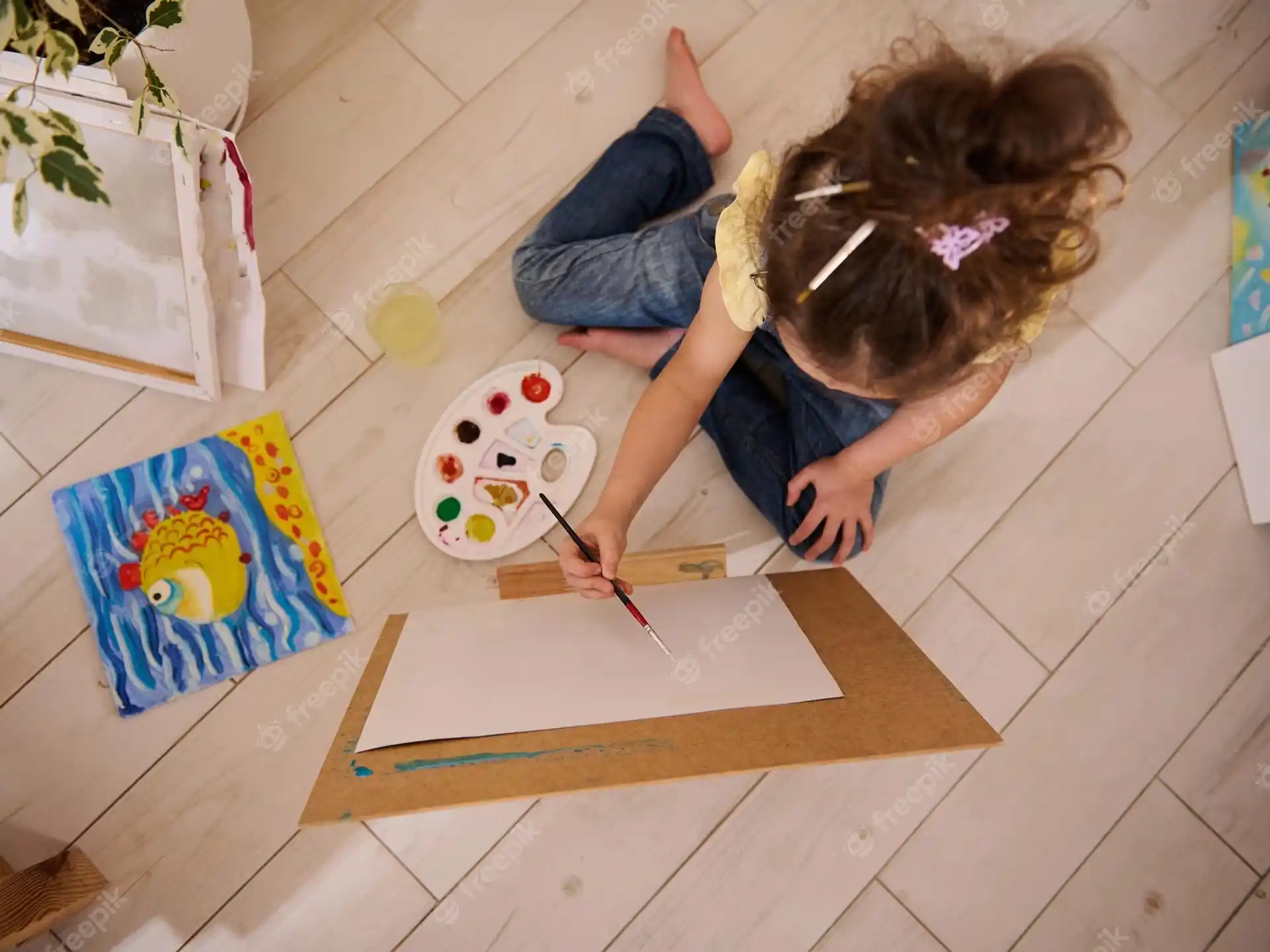 a child painting on the floor