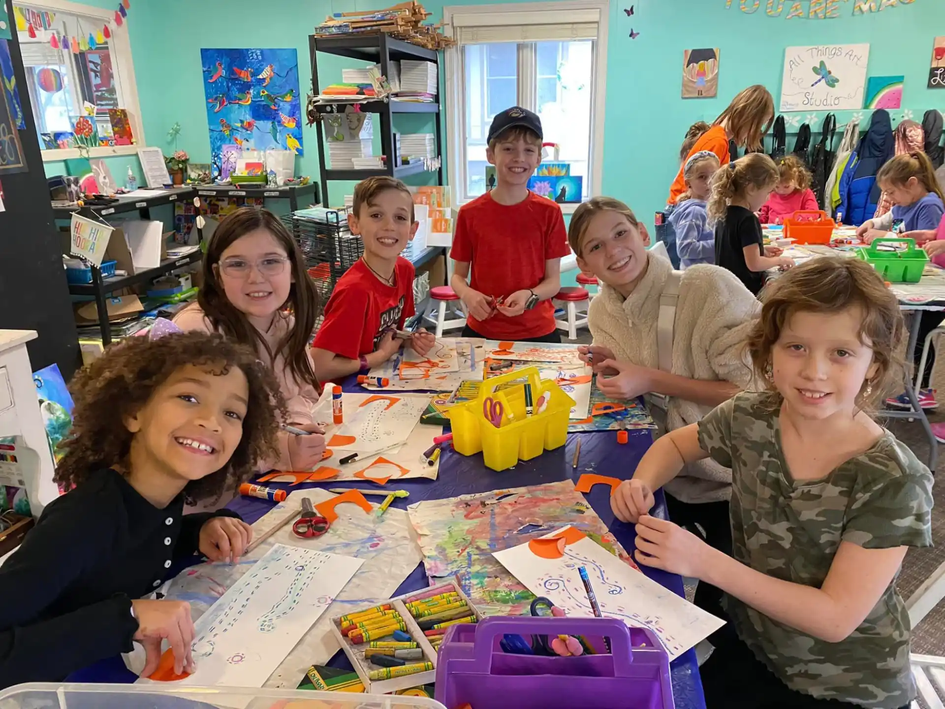 a group of children sitting at a table