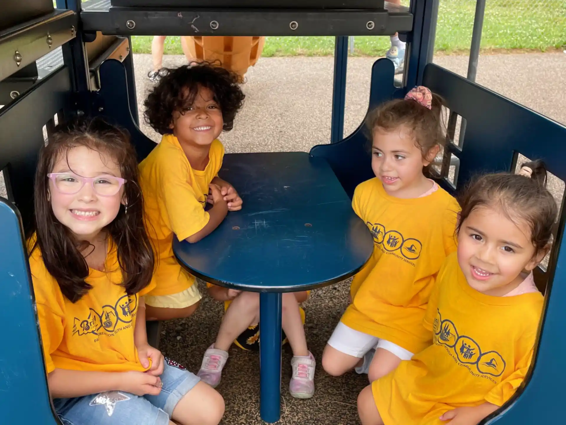 a group of children sitting at a table