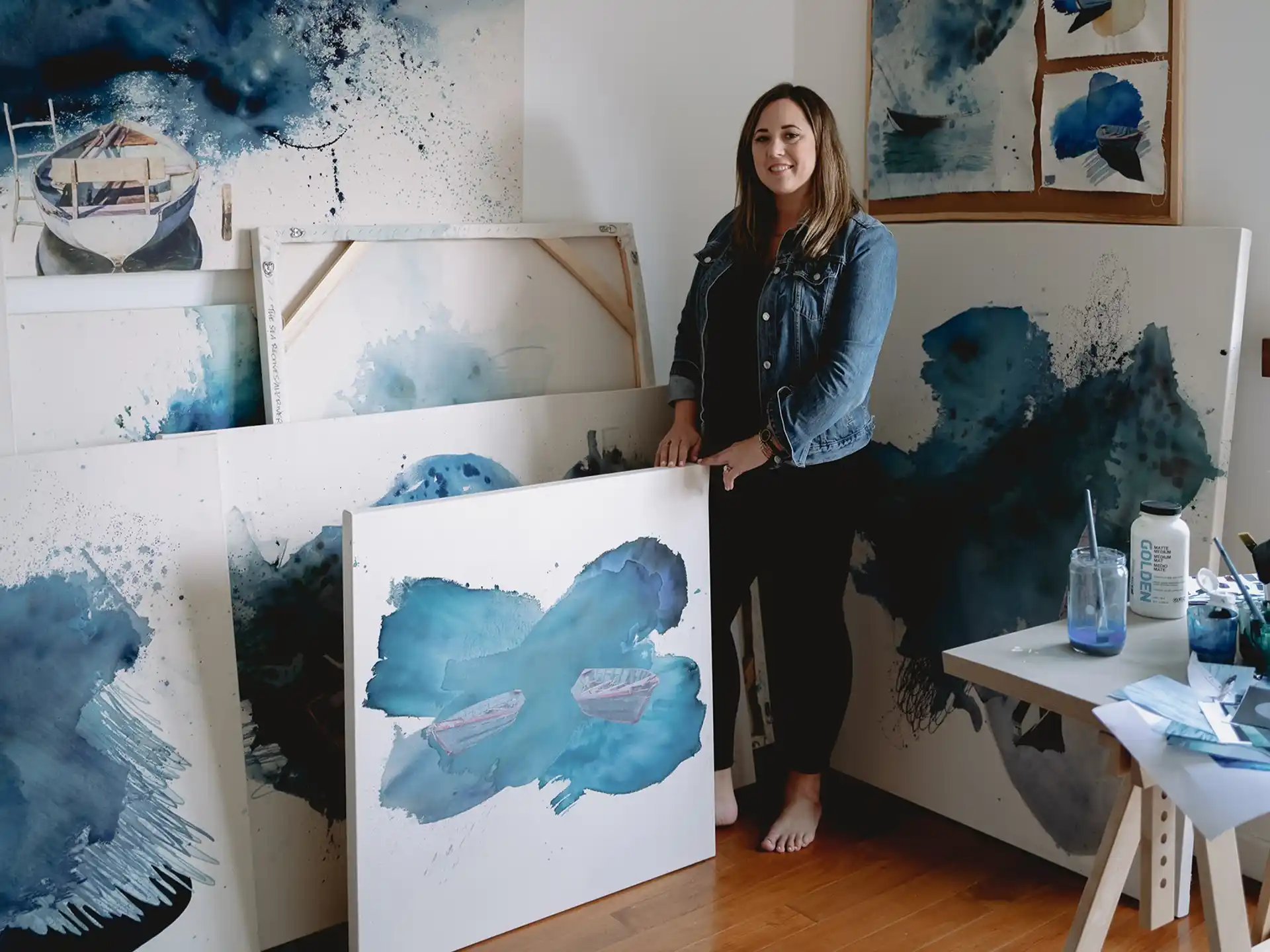 a person standing next to a painting