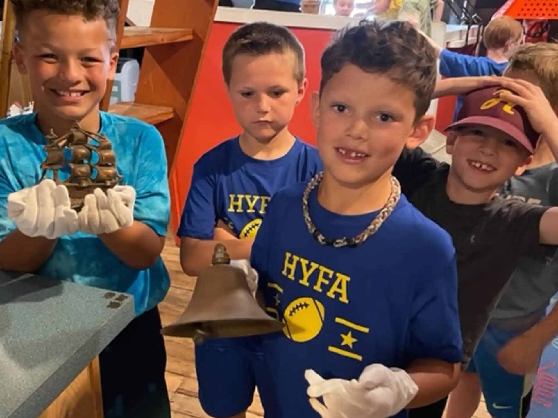 a group of children in blue shirts