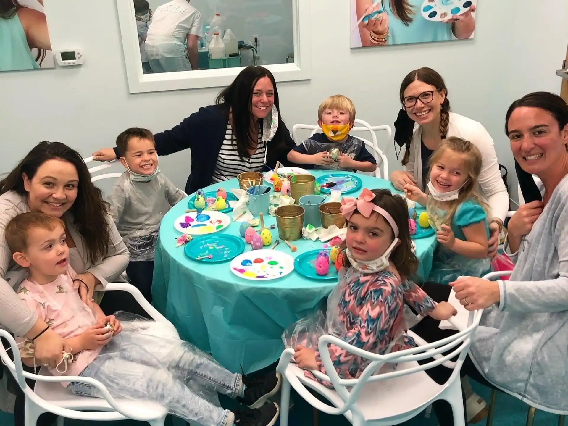 a group of people sitting around a table with food on it