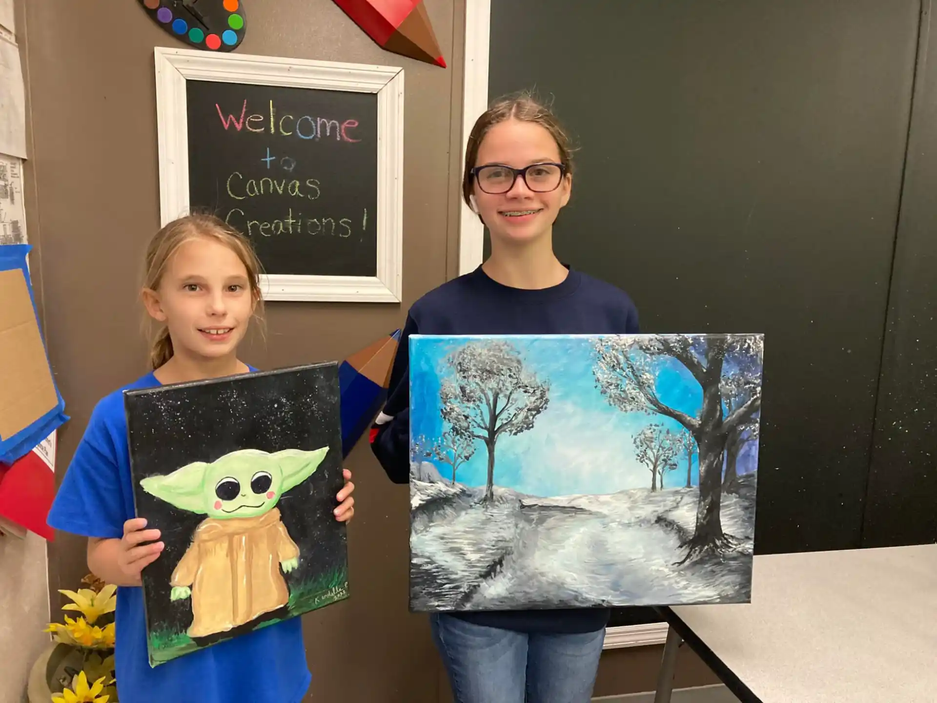 a person and a girl holding a drawing