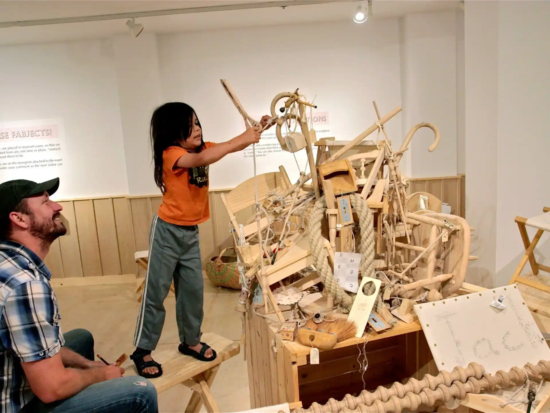 a man and a woman working on a sculpture