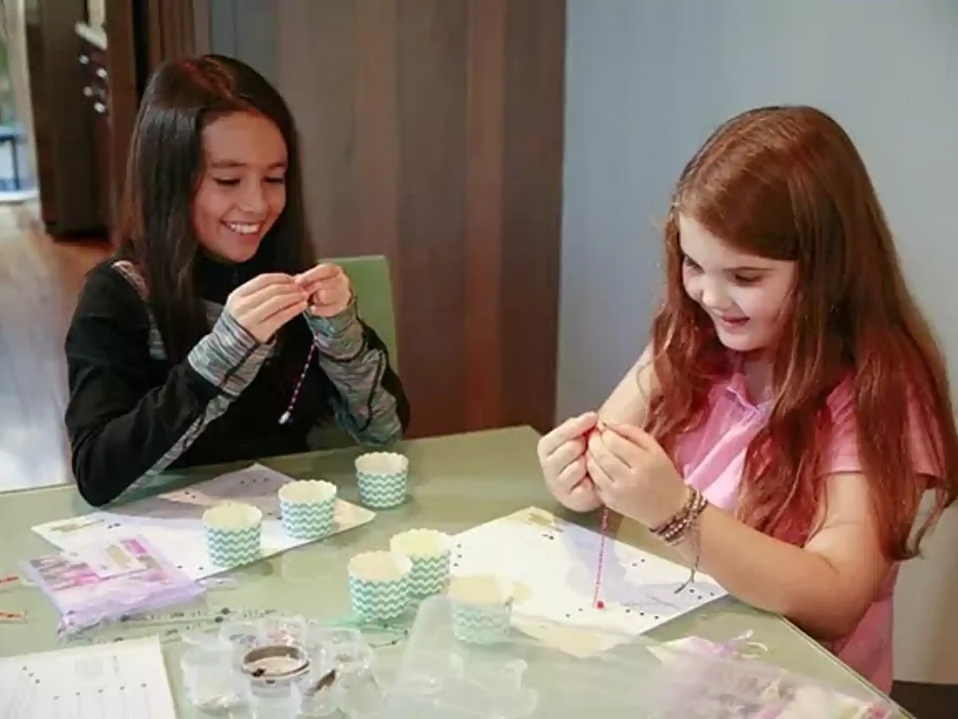 a couple of women sitting at a table with a cupcake and a cupcake