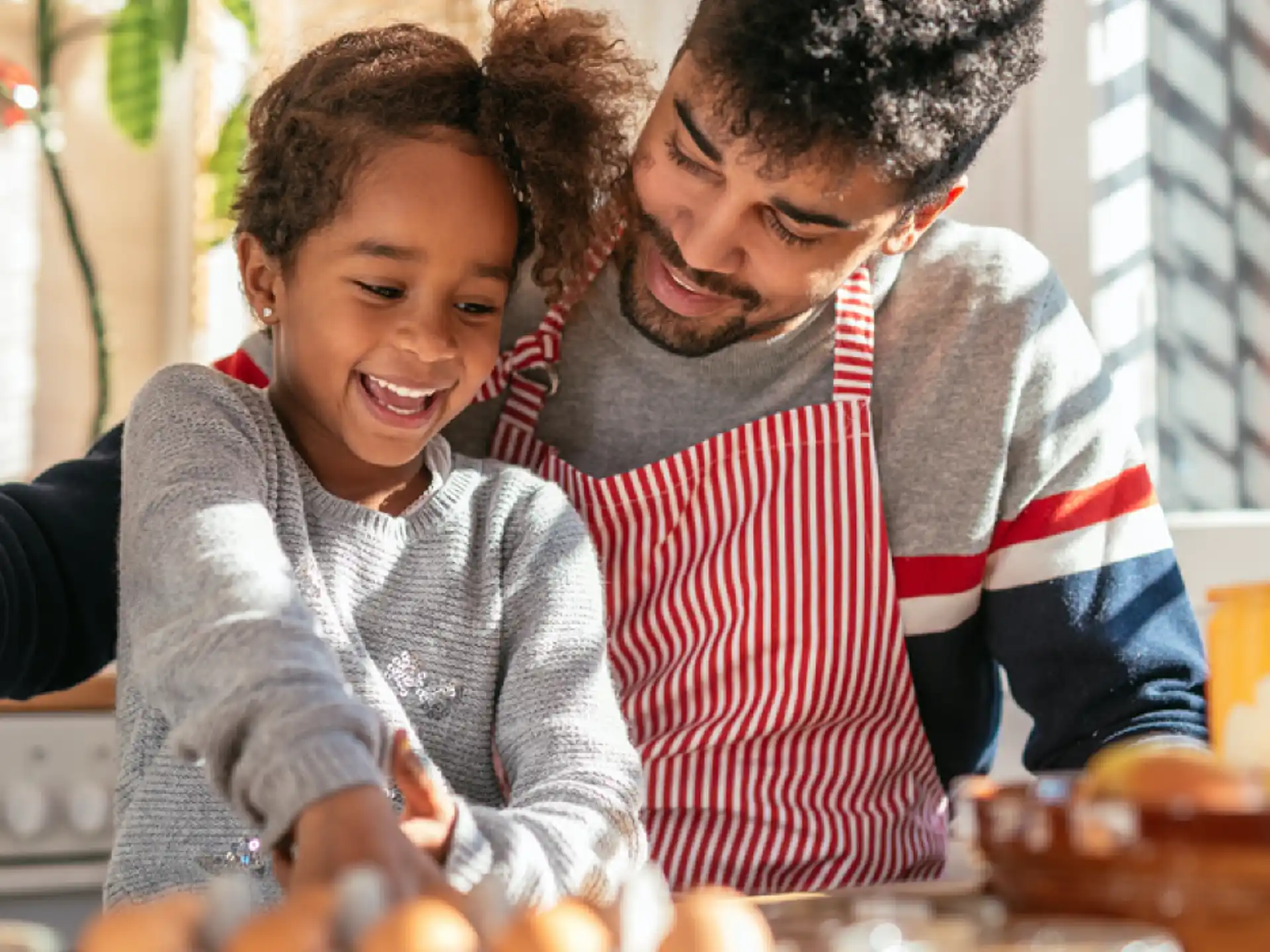 a person and a child making a cake