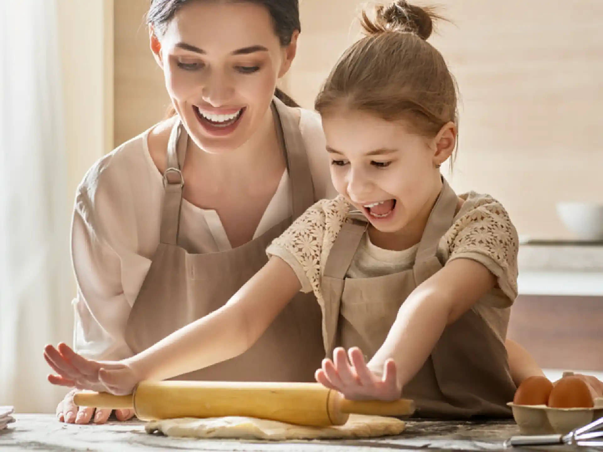 a woman and a child making a sandwich