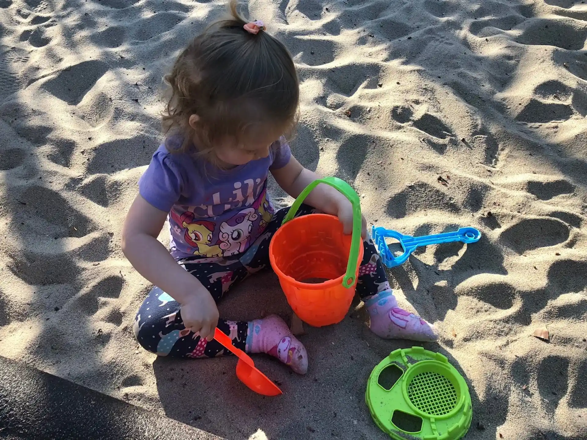 a baby playing in the sand