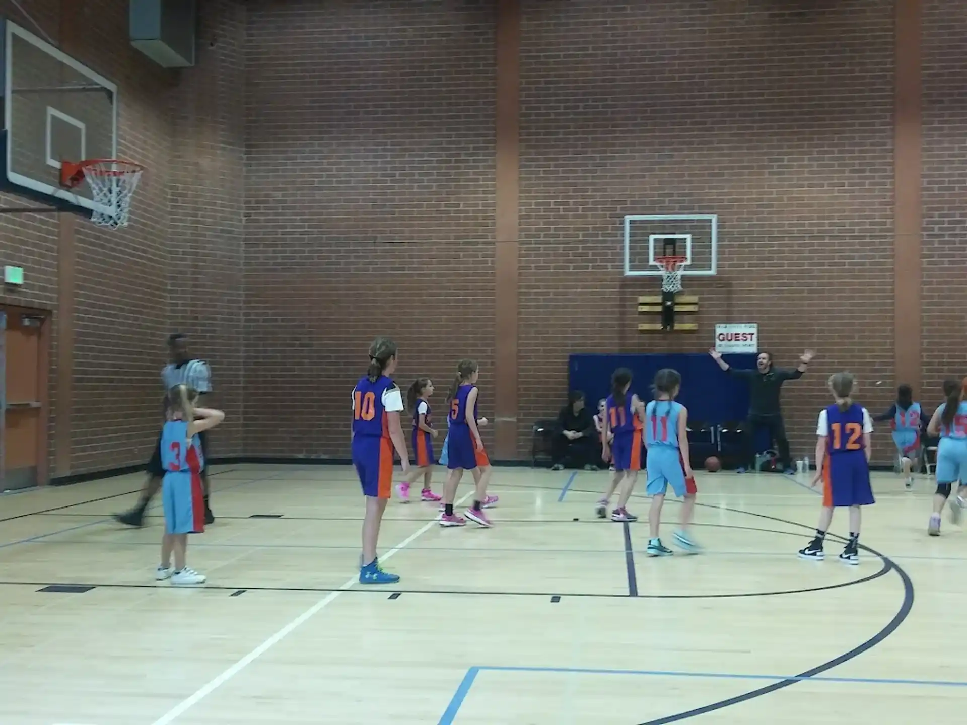 a group of people playing basketball