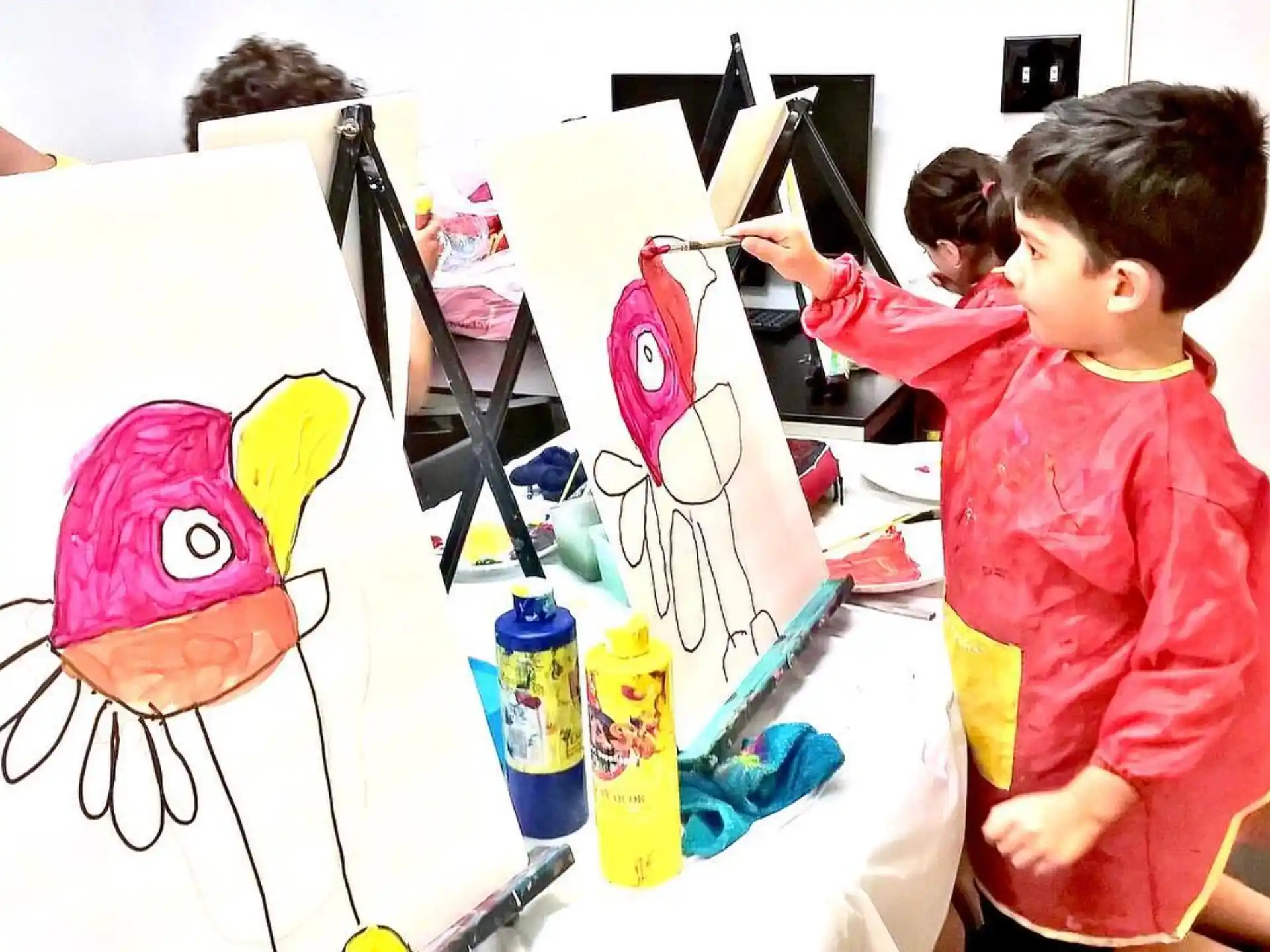 a group of children painting