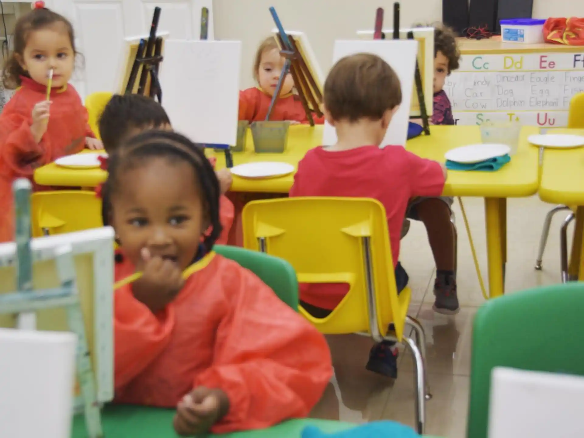 a group of children sitting at desks in a classroom