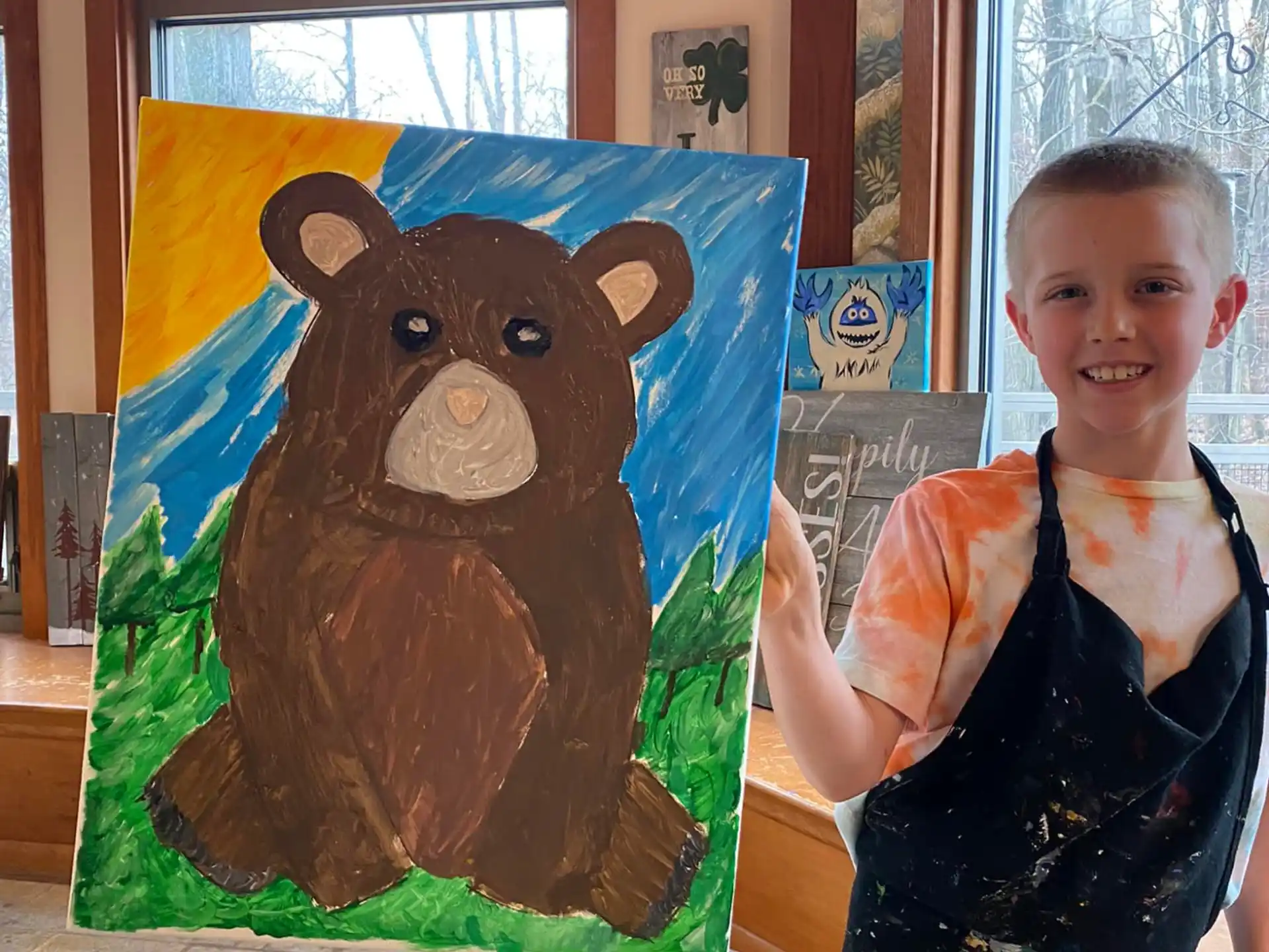 a boy holding a painting