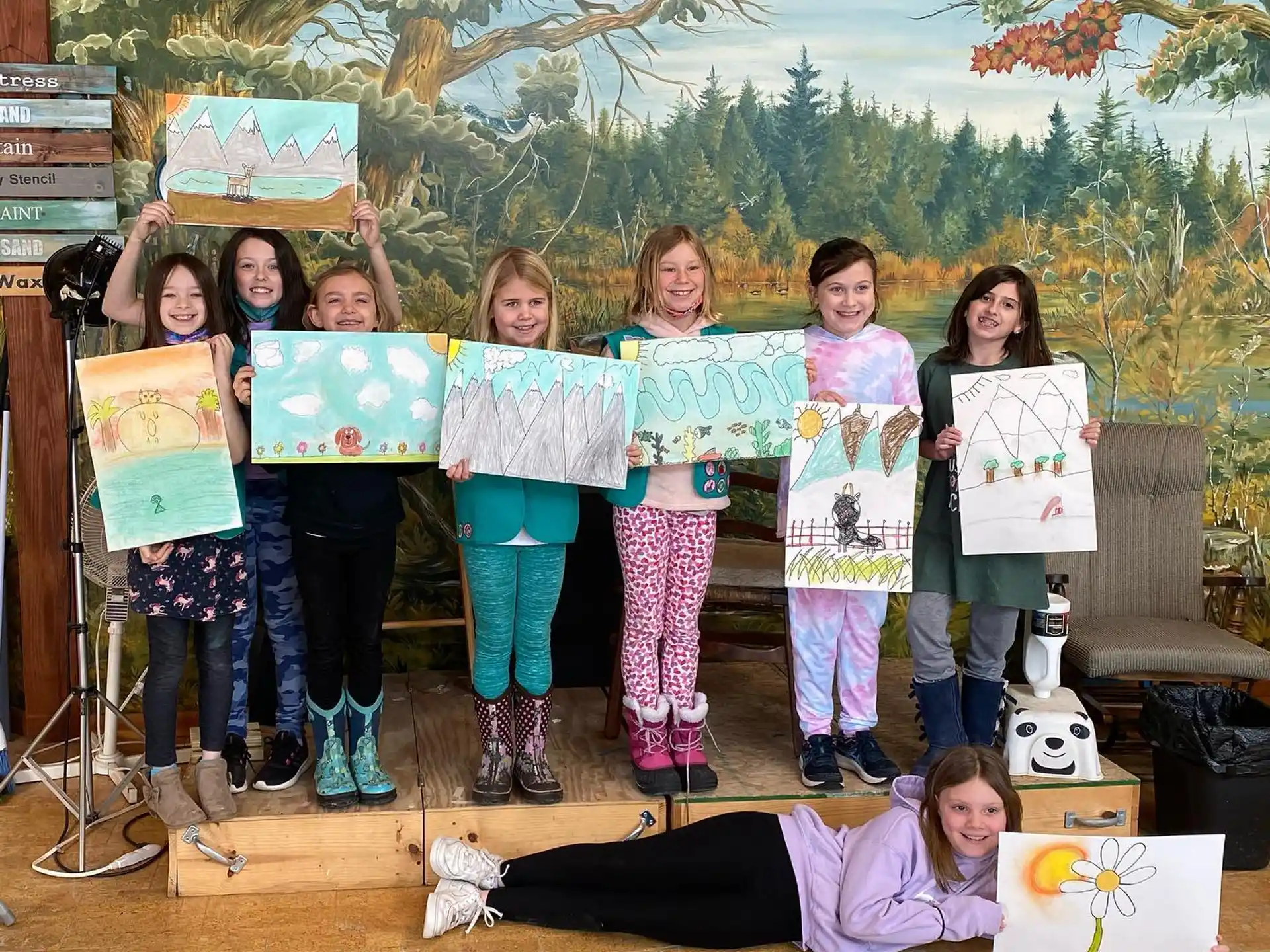 a group of girls holding signs
