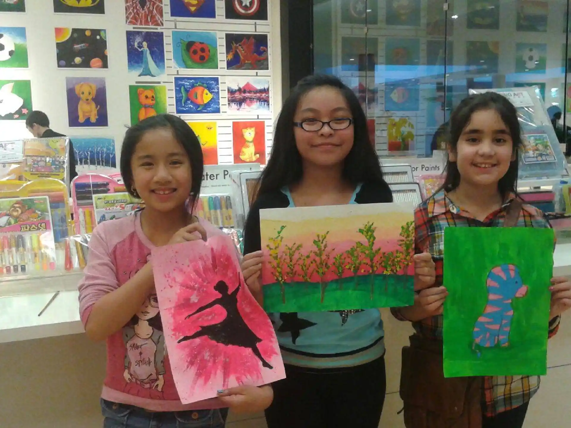 a group of girls holding up a piece of paper