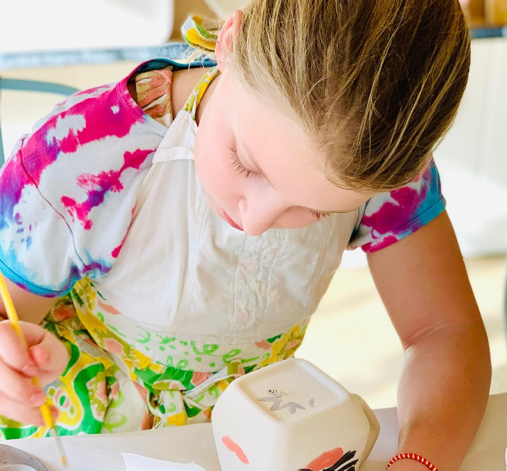 a young girl coloring on a book
