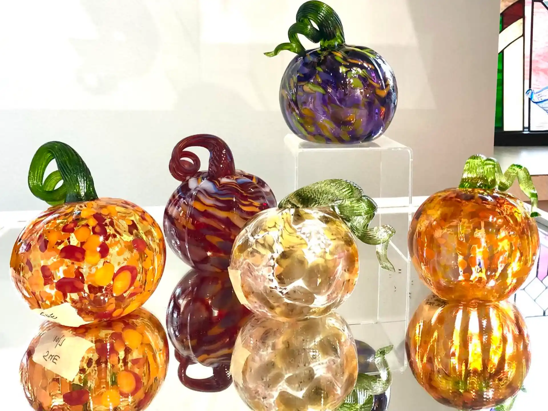 a group of glass vases with fruit in them