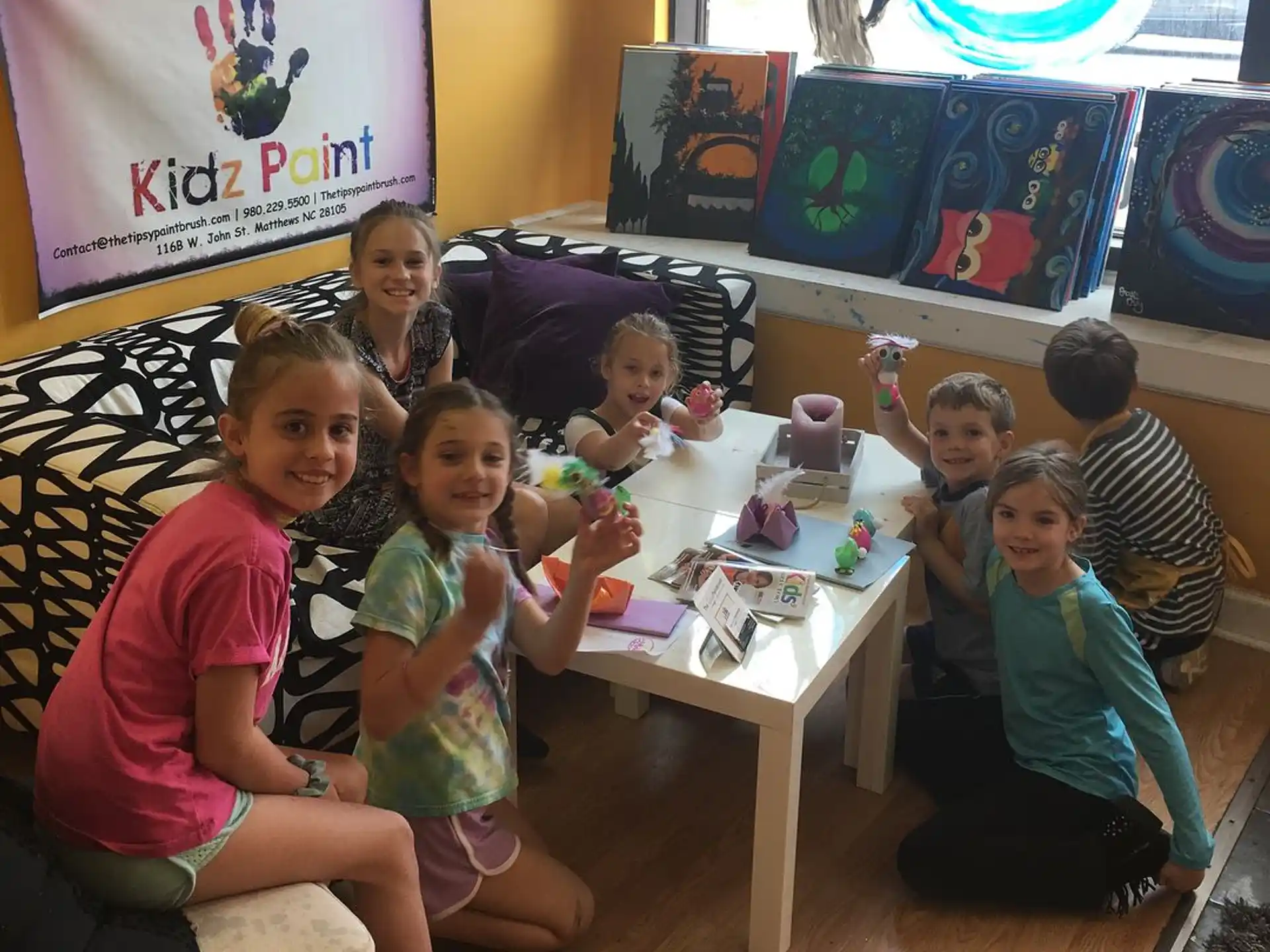 a group of people sitting around a table with a game on it