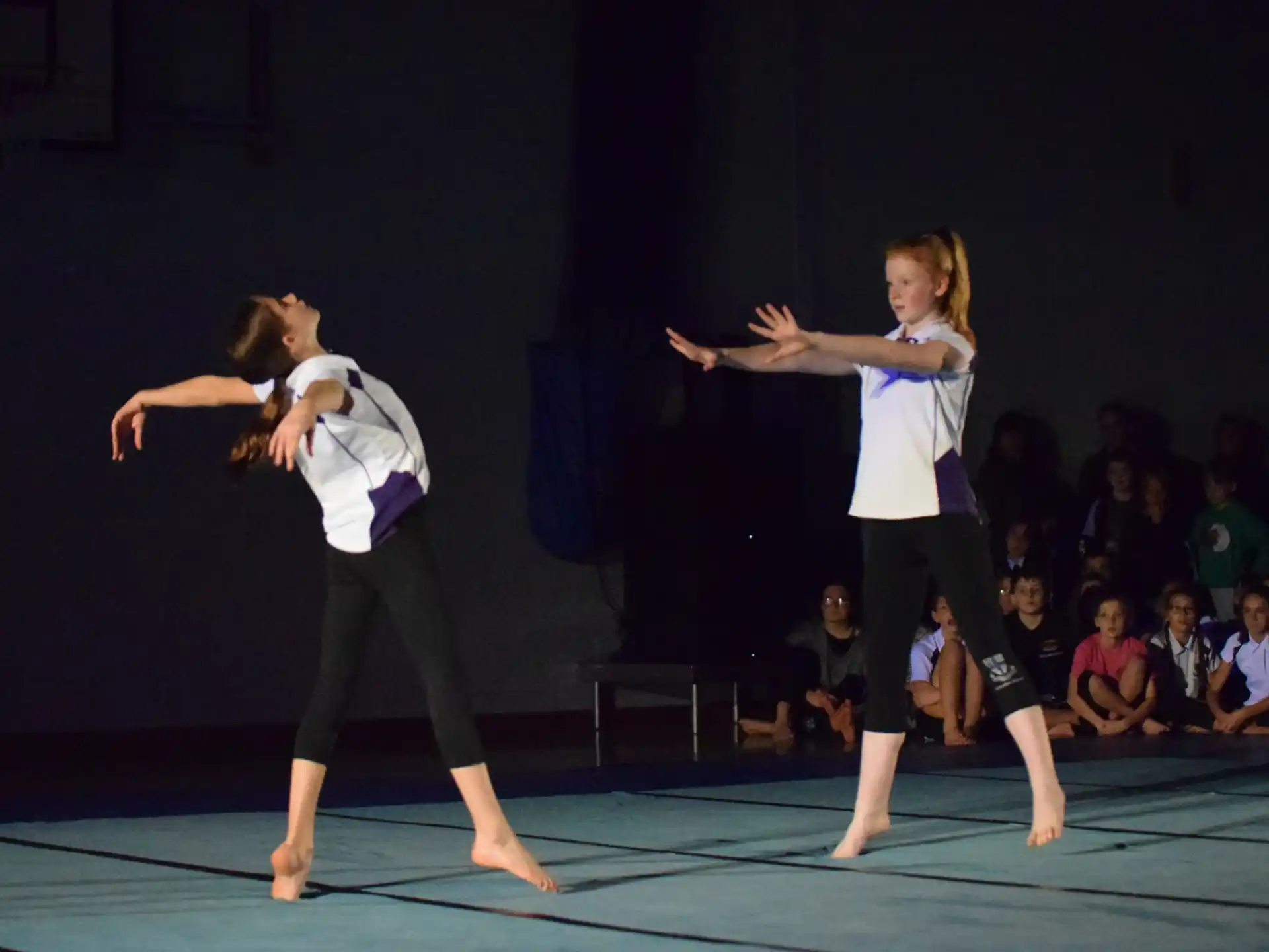 a couple of women dancing on a stage