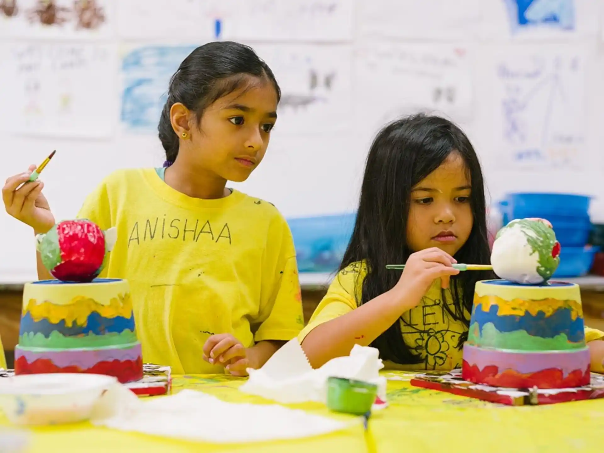 a couple of young girls painting