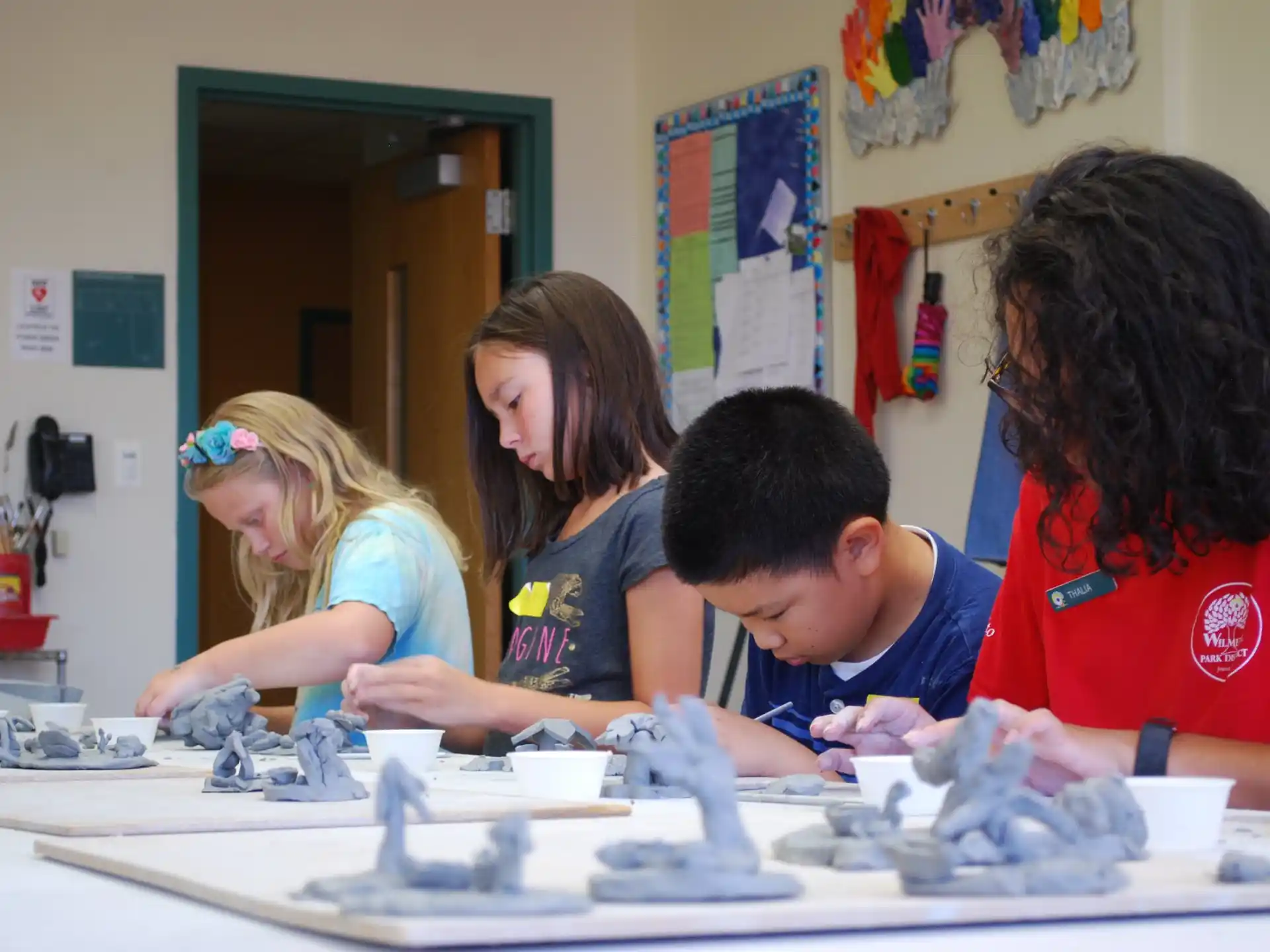 a group of people looking at a model of a building