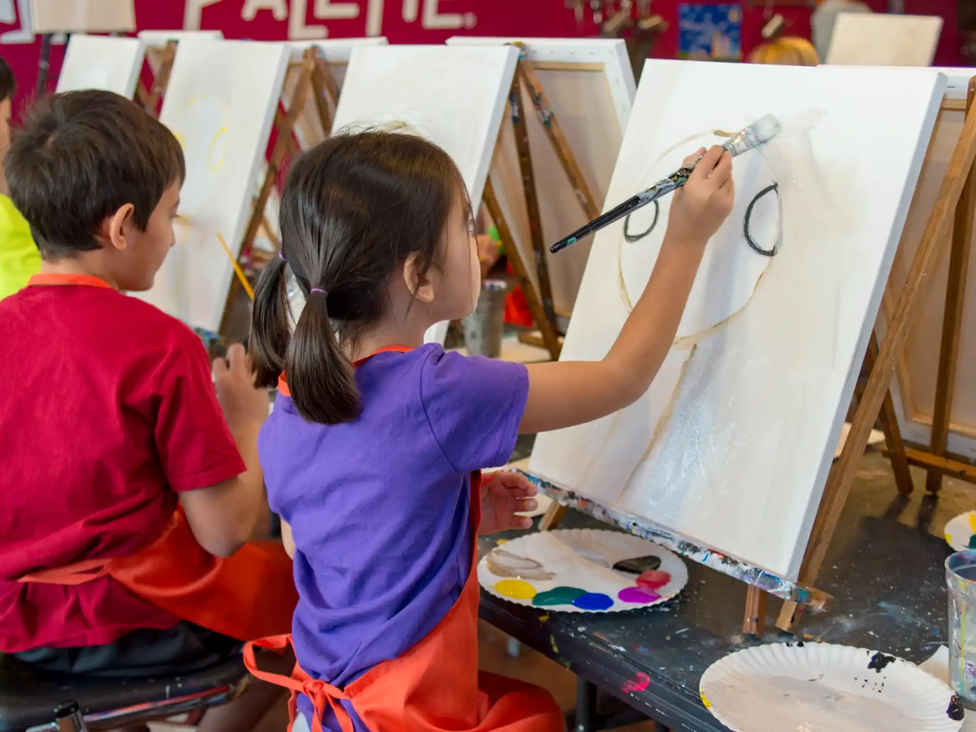 a group of children painting