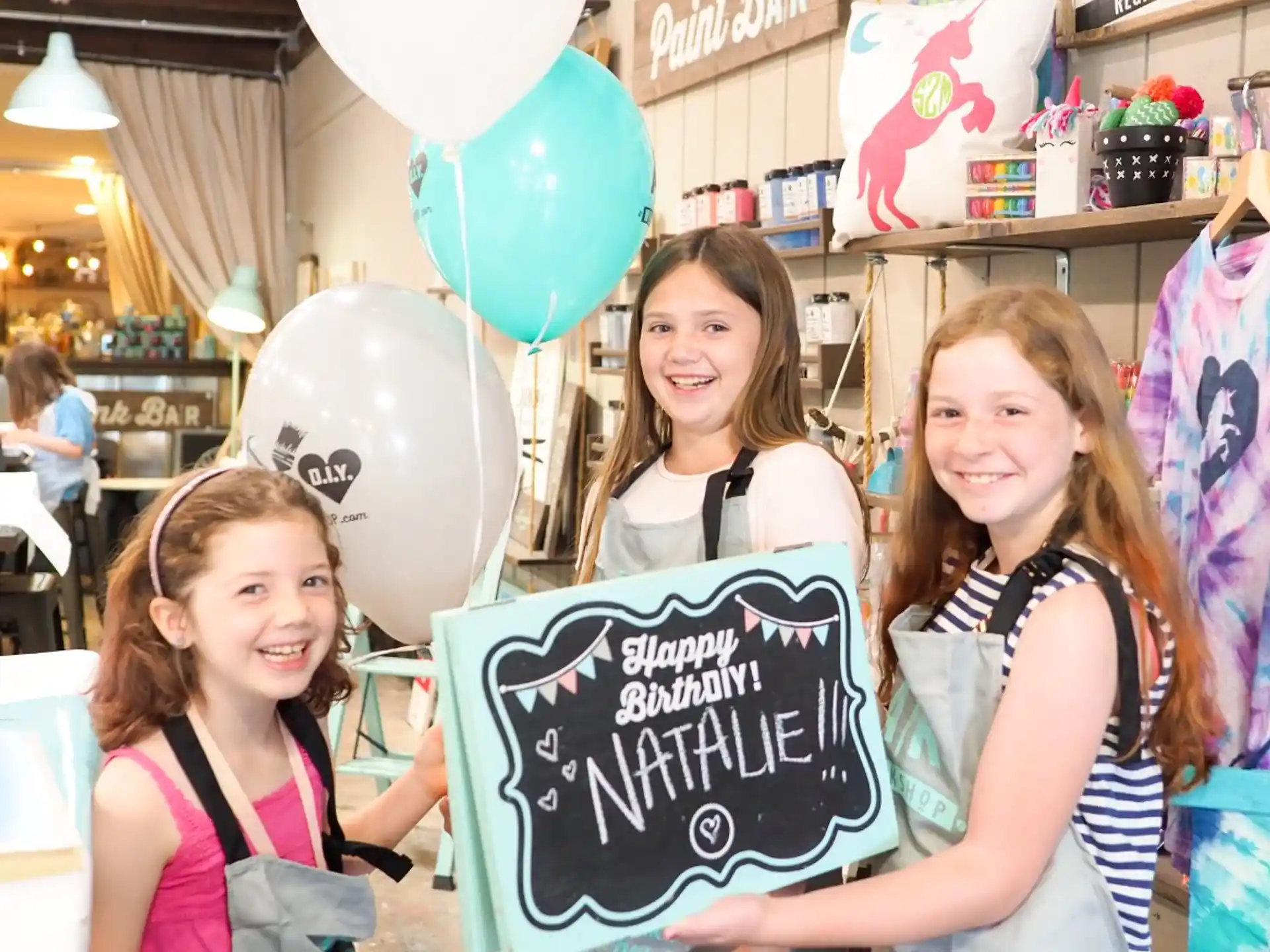 a group of girls holding a sign