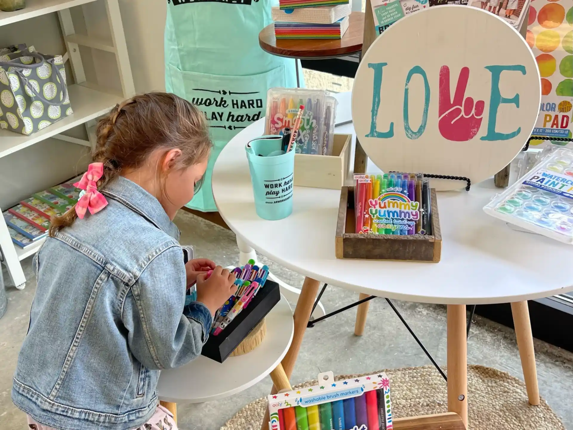 a person sitting at a table with a cake and a sign