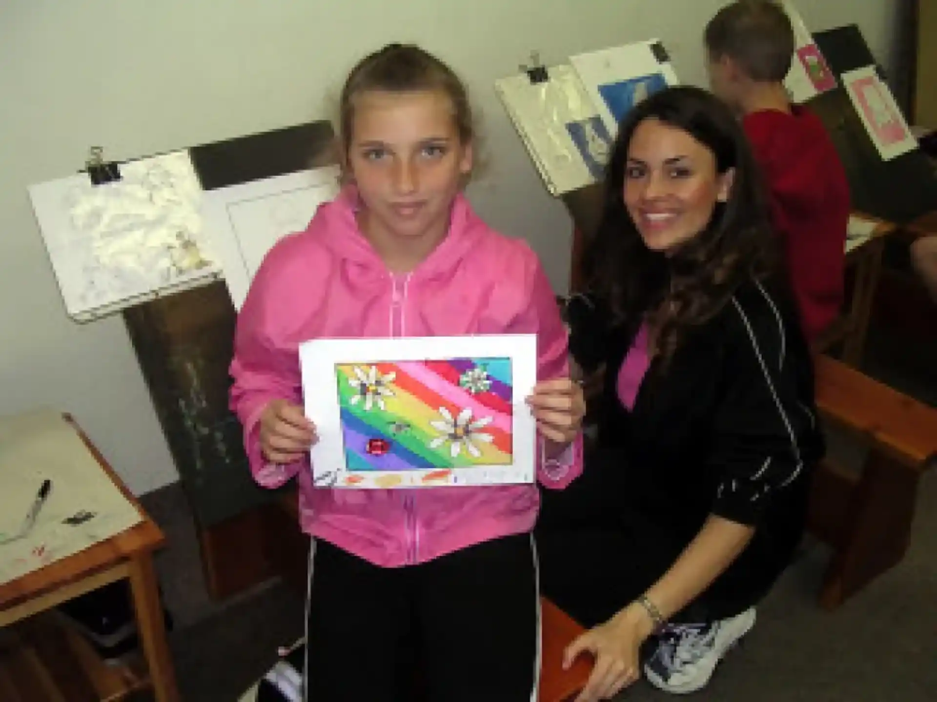 a boy and girl holding a picture
