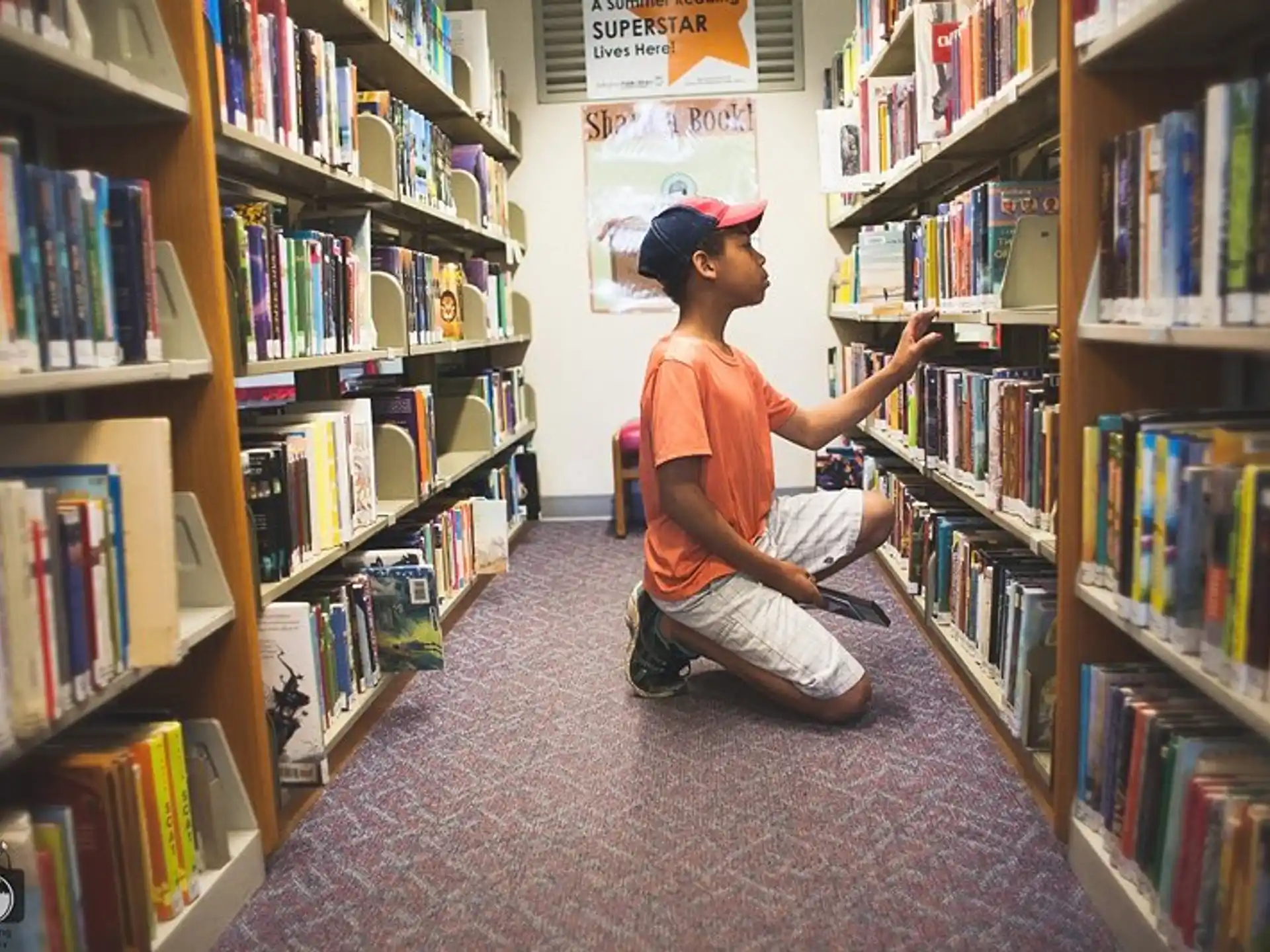 a boy sitting in a library
