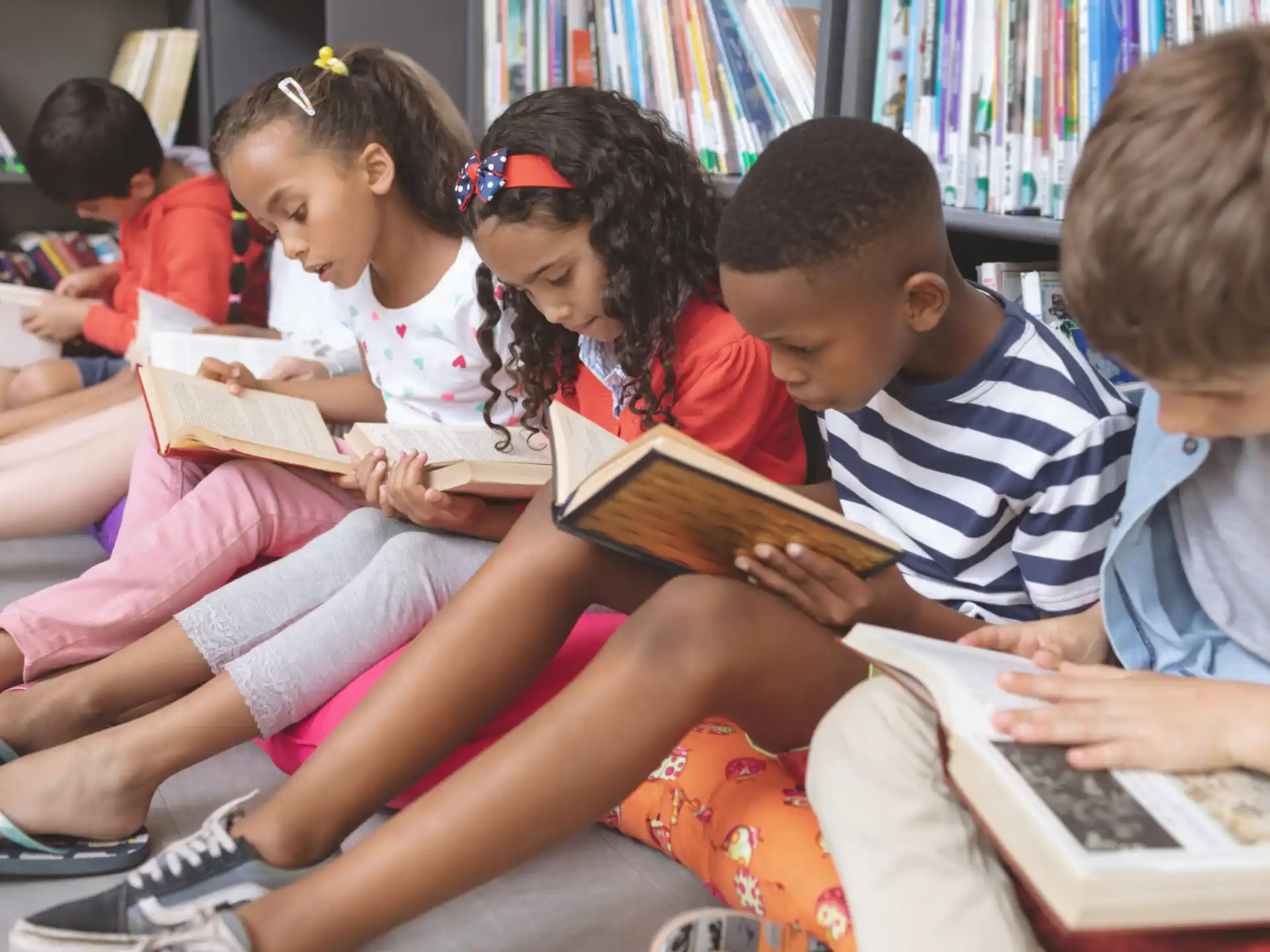 a group of children reading books