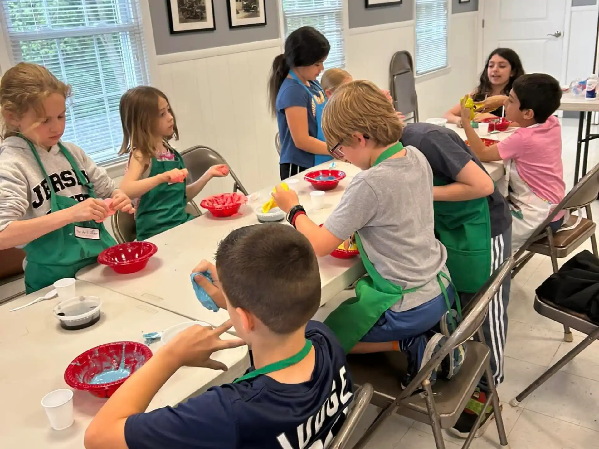 a group of children sitting at a table eating food
