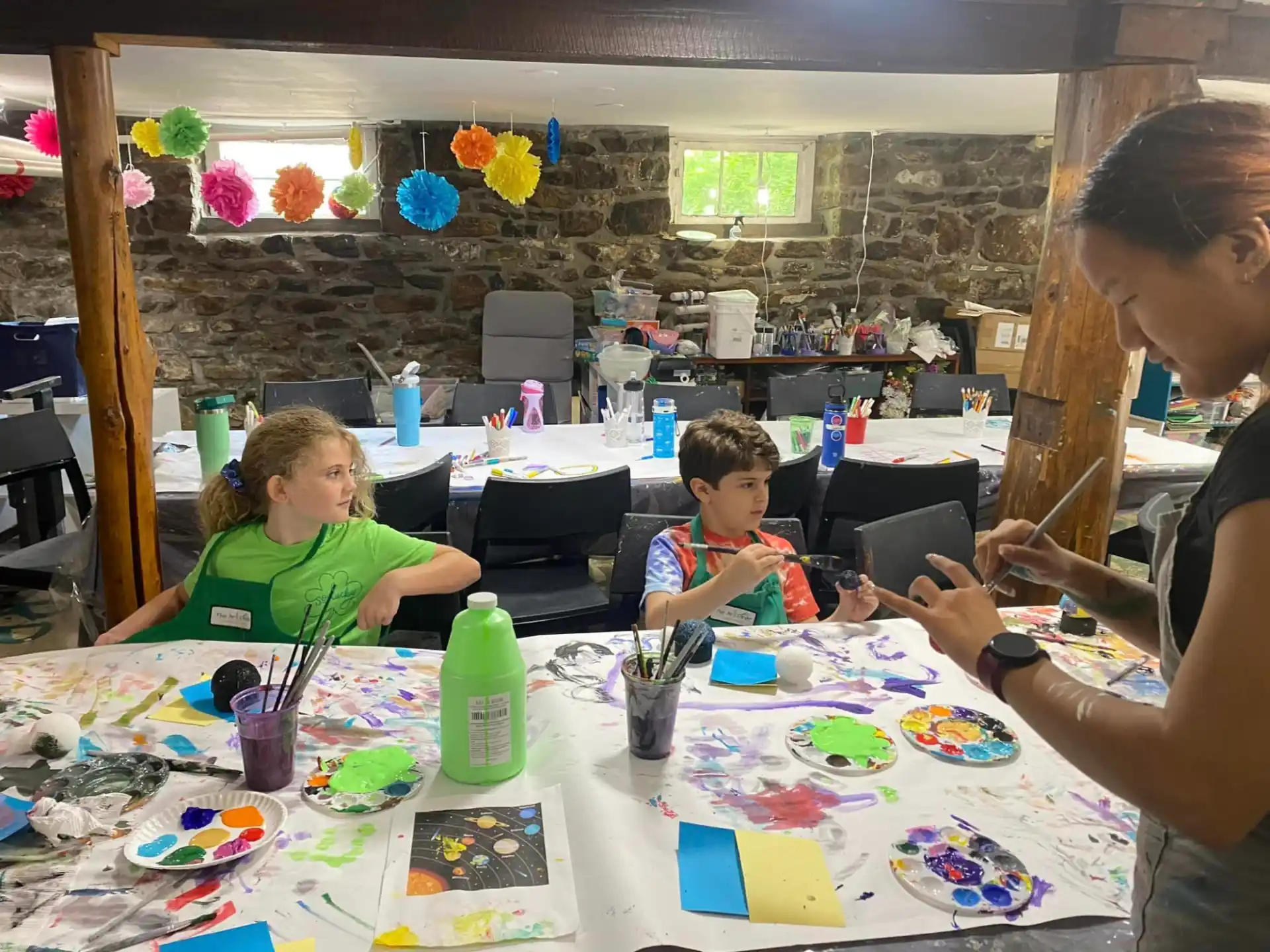 a person and two children sitting at a table