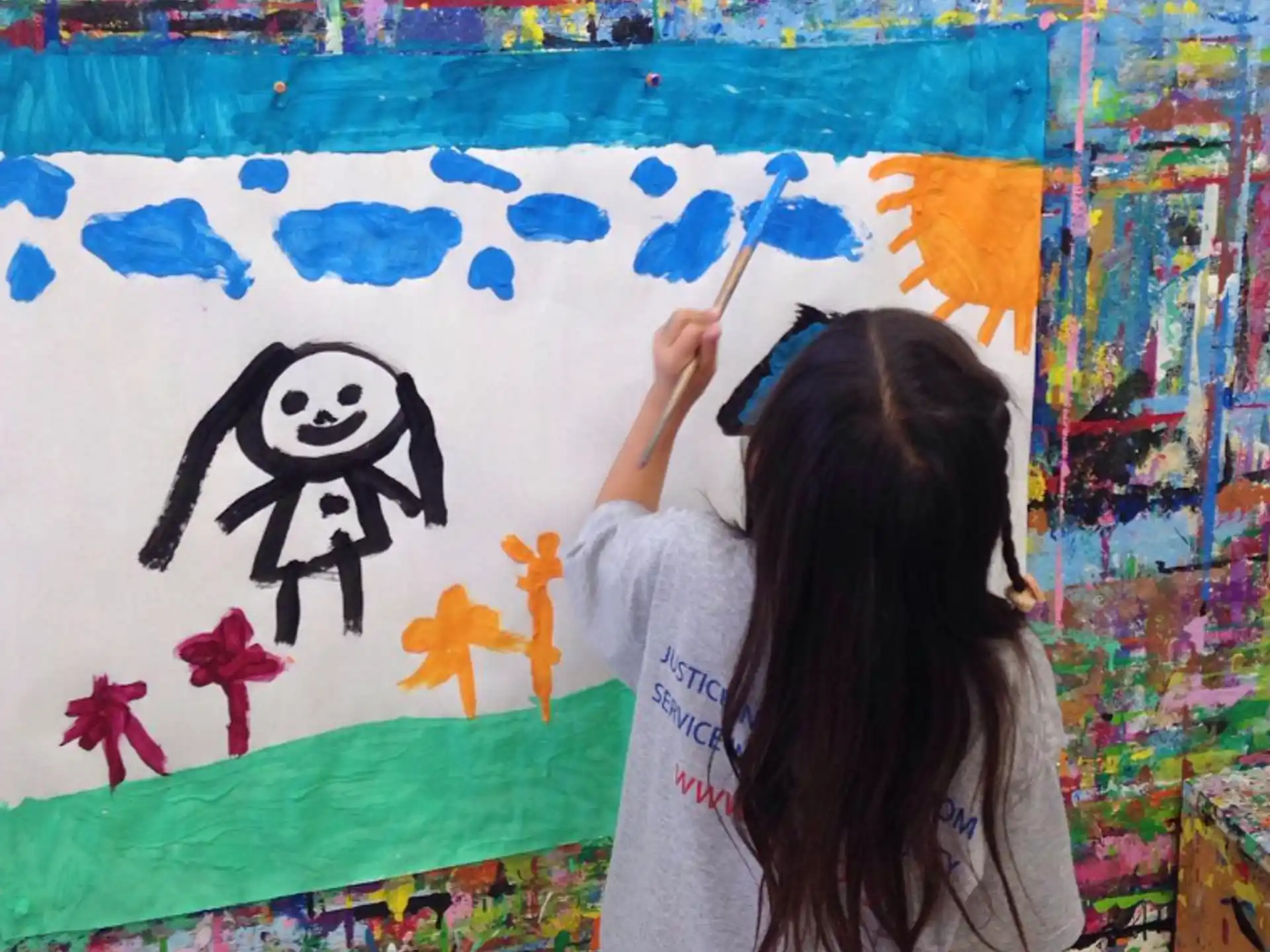 a girl painting on a wall