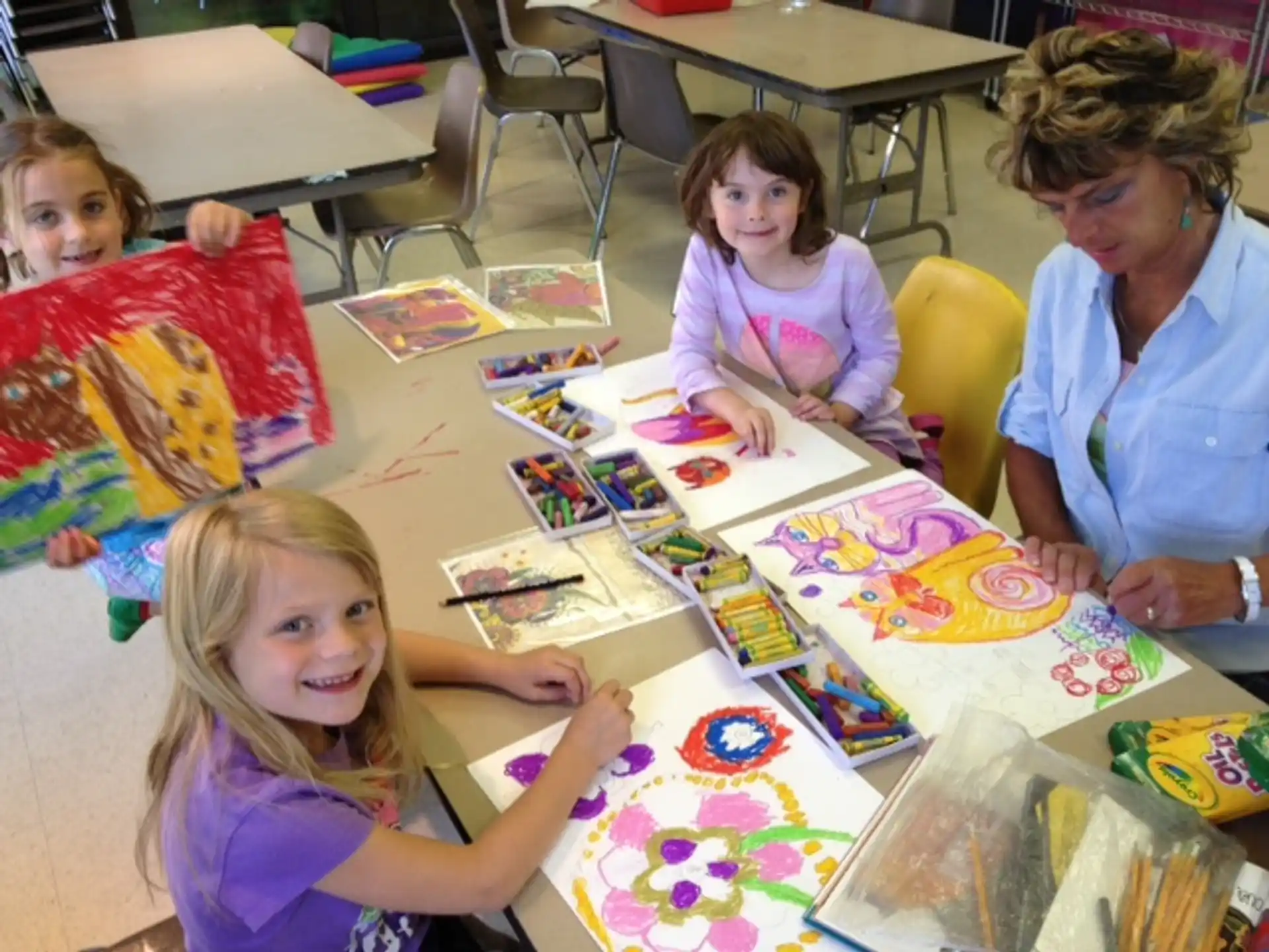 a person and several children sitting at a table