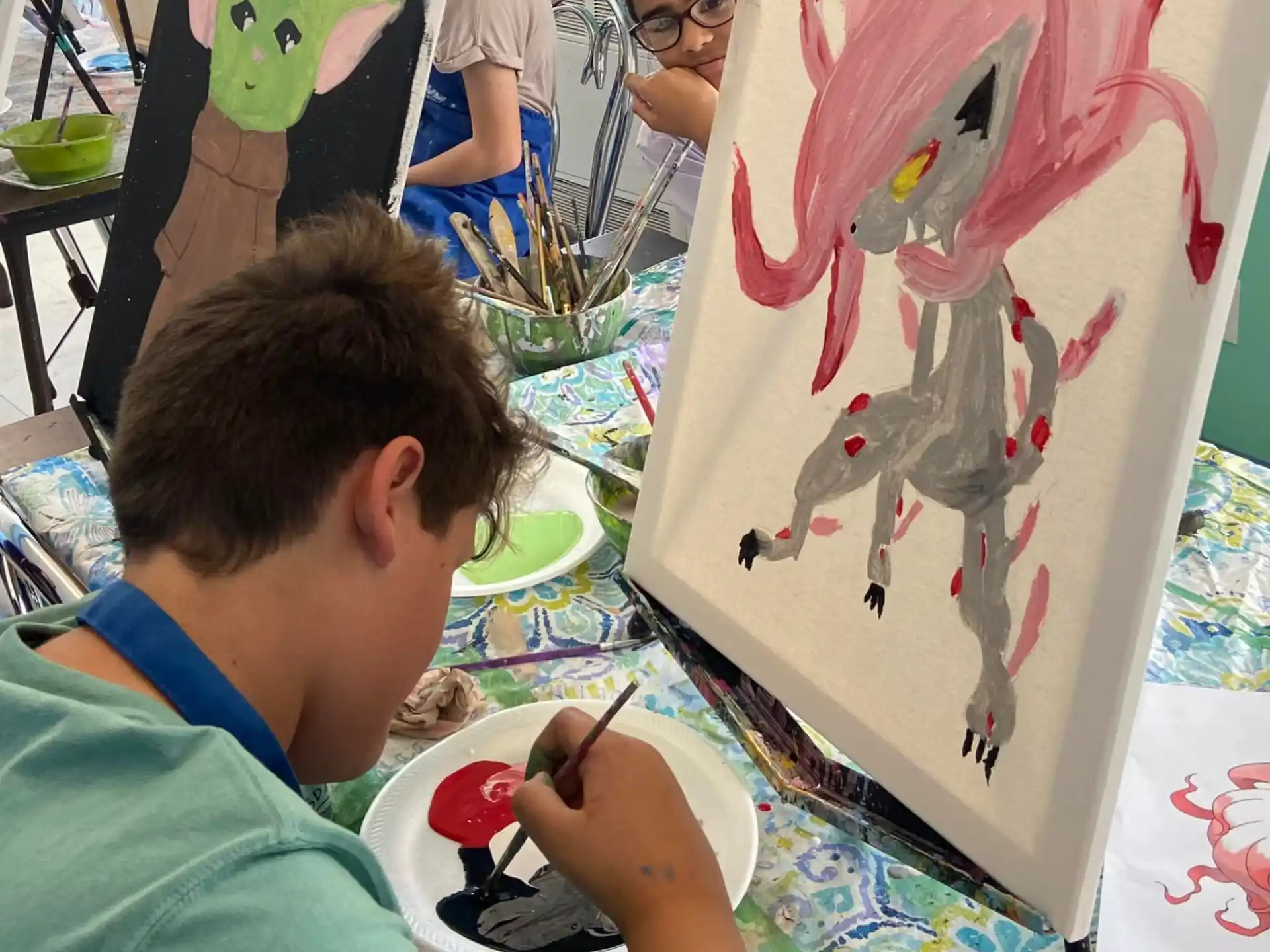 a boy painting a snowman