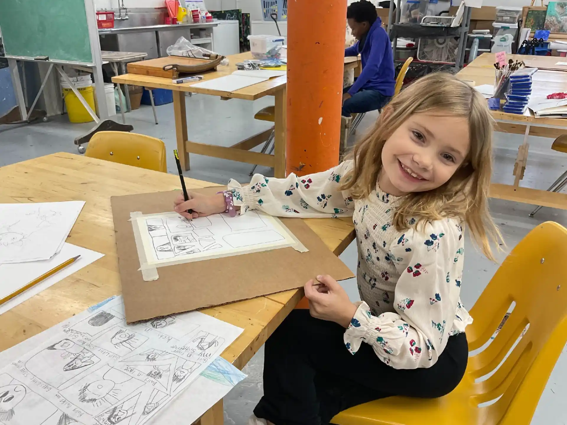 a girl sitting at a table