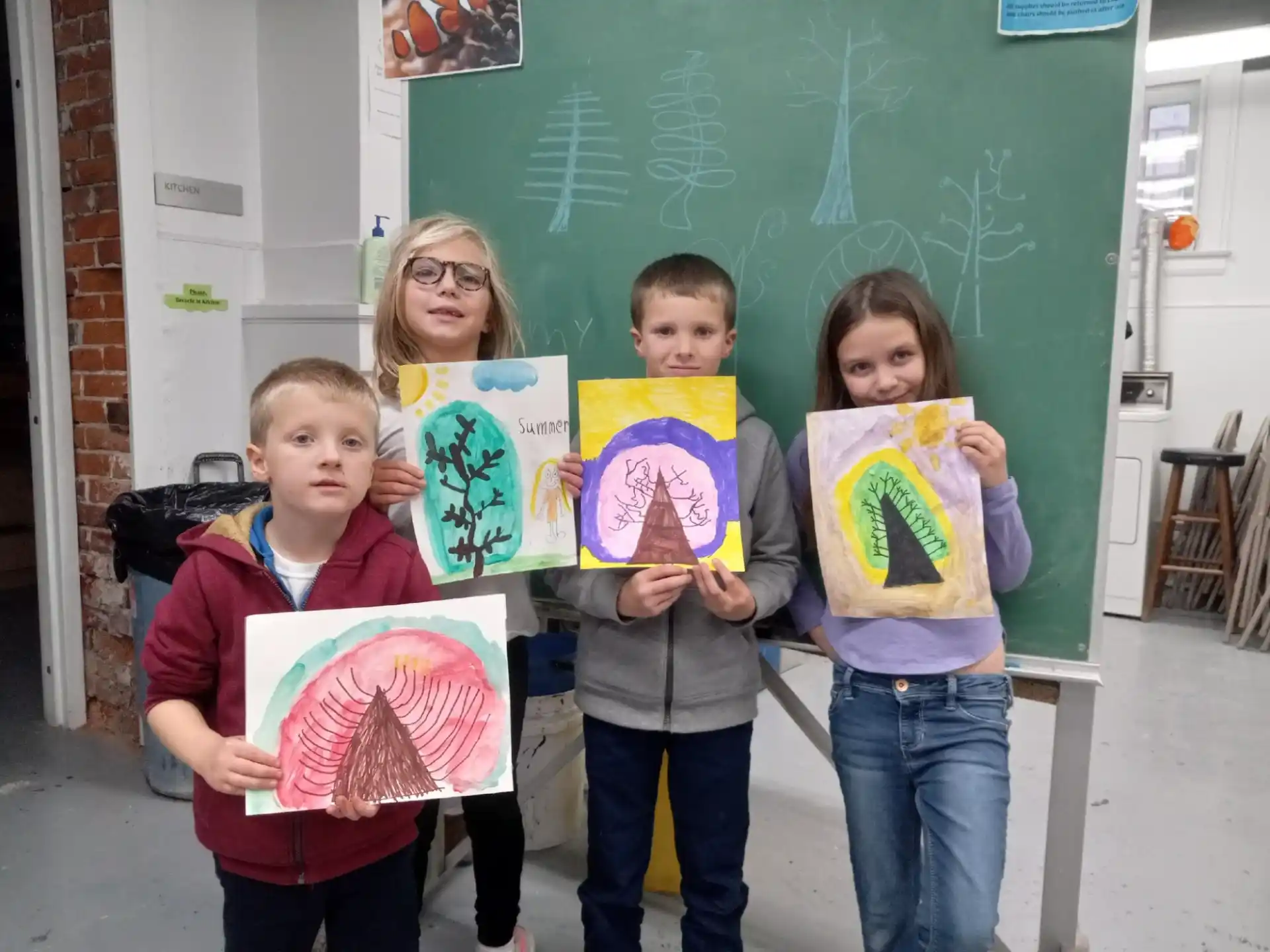 a group of children holding up posters