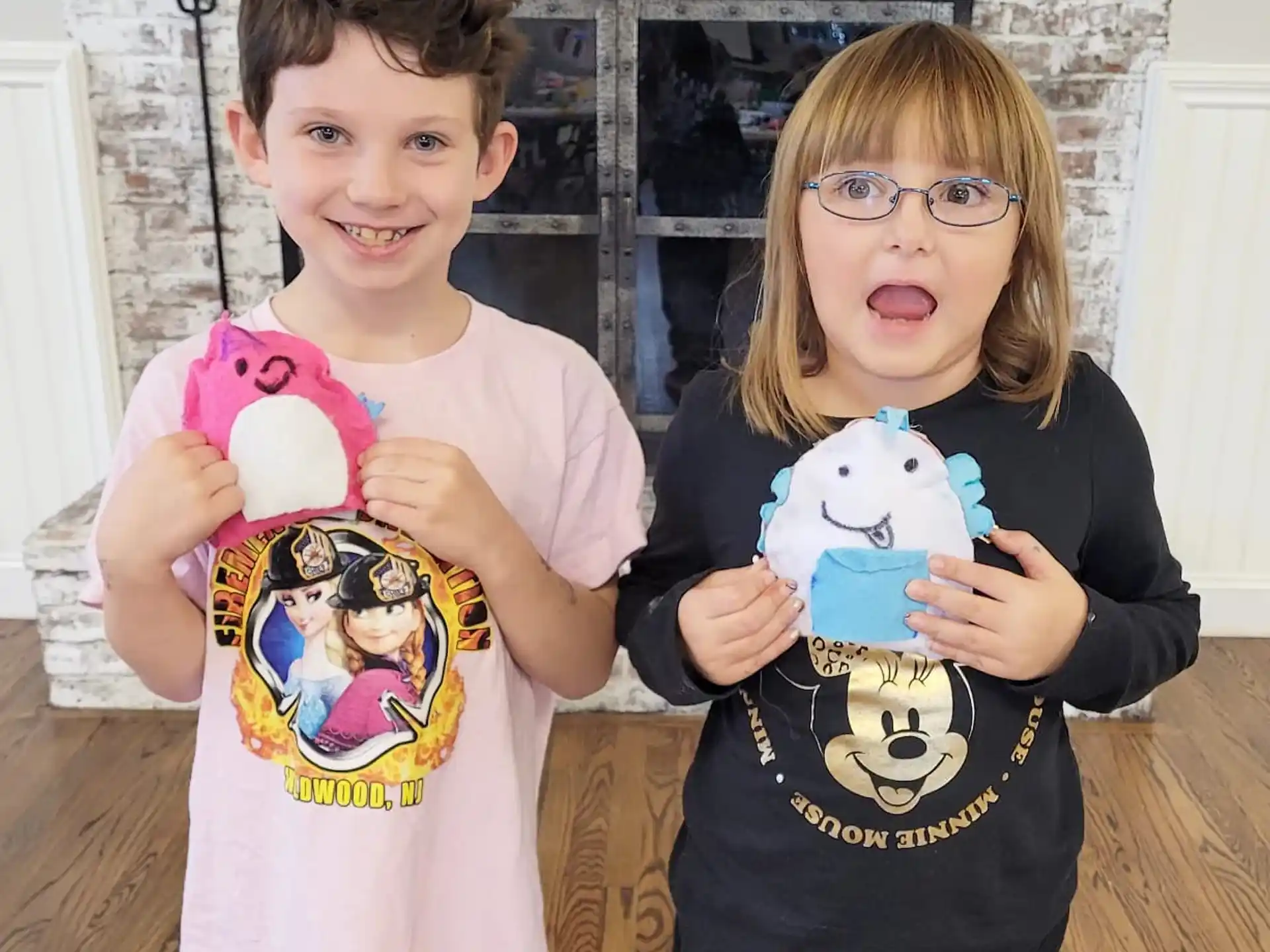 a couple of children holding stuffed animals