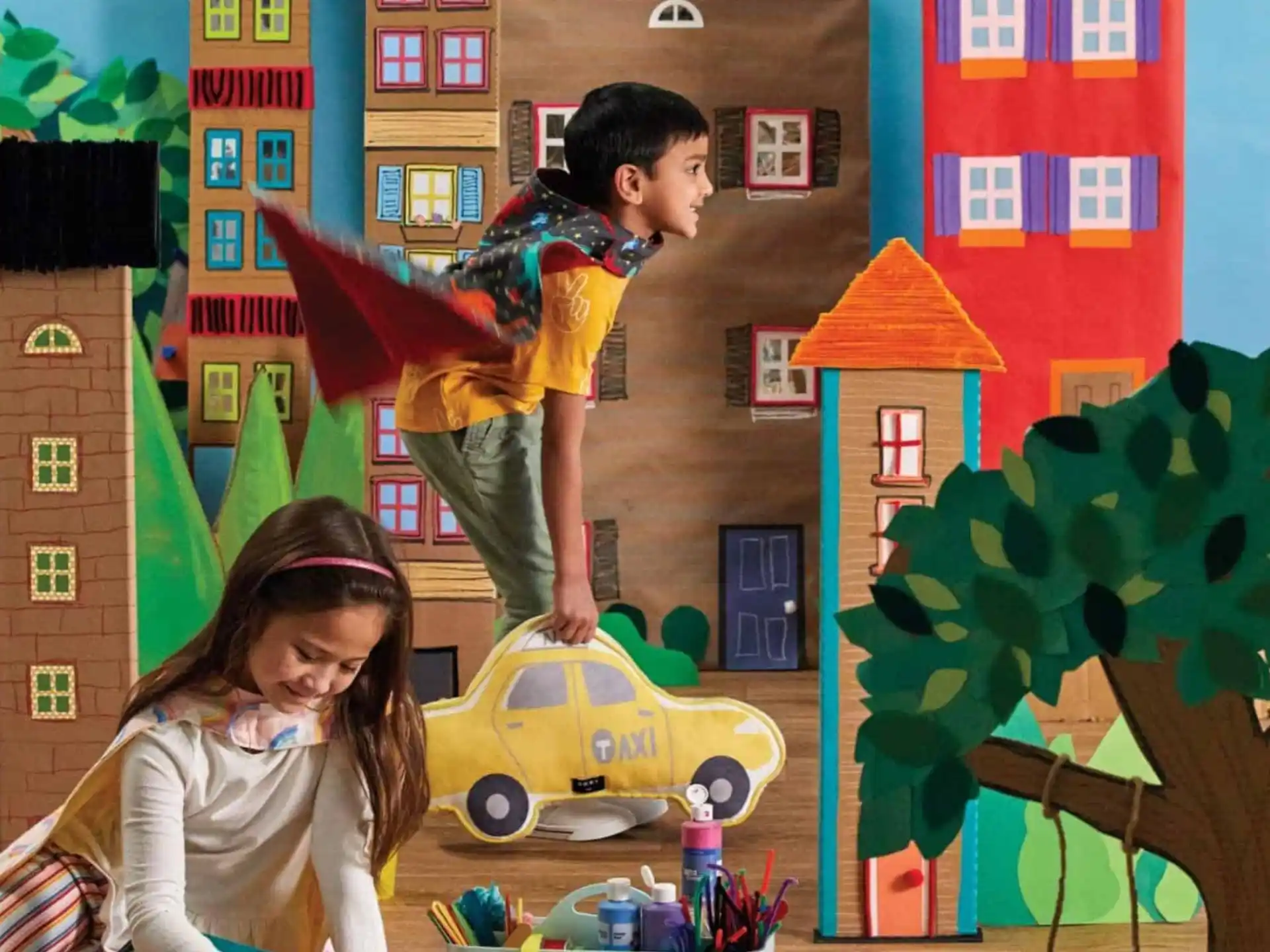 a boy riding a toy car