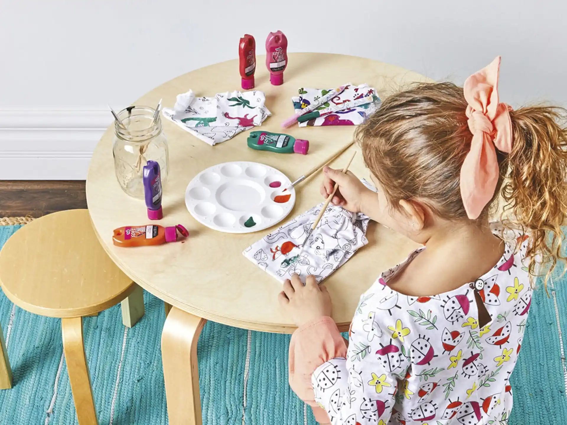 a girl painting on a table