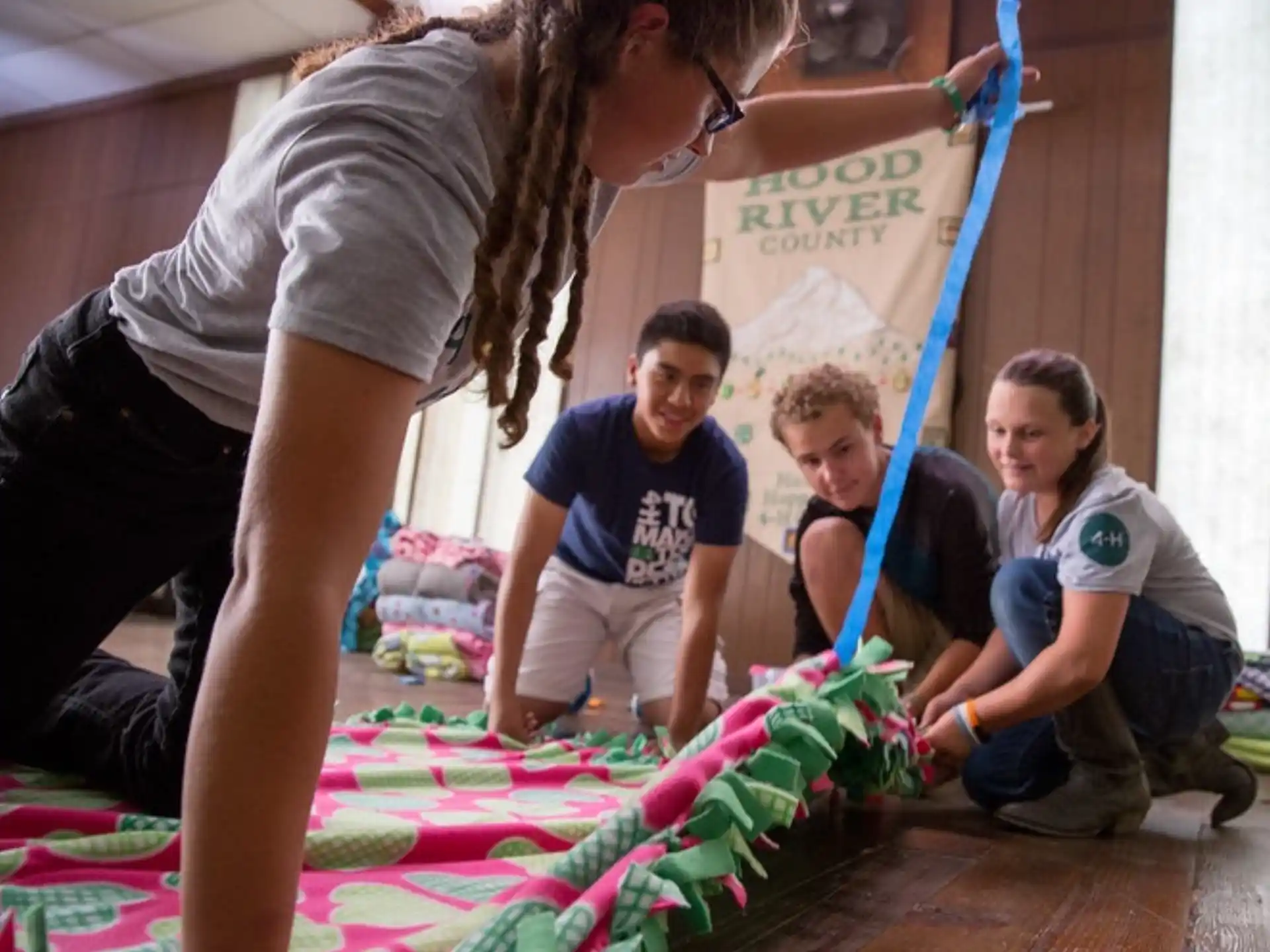 a person helping a group of kids with a project