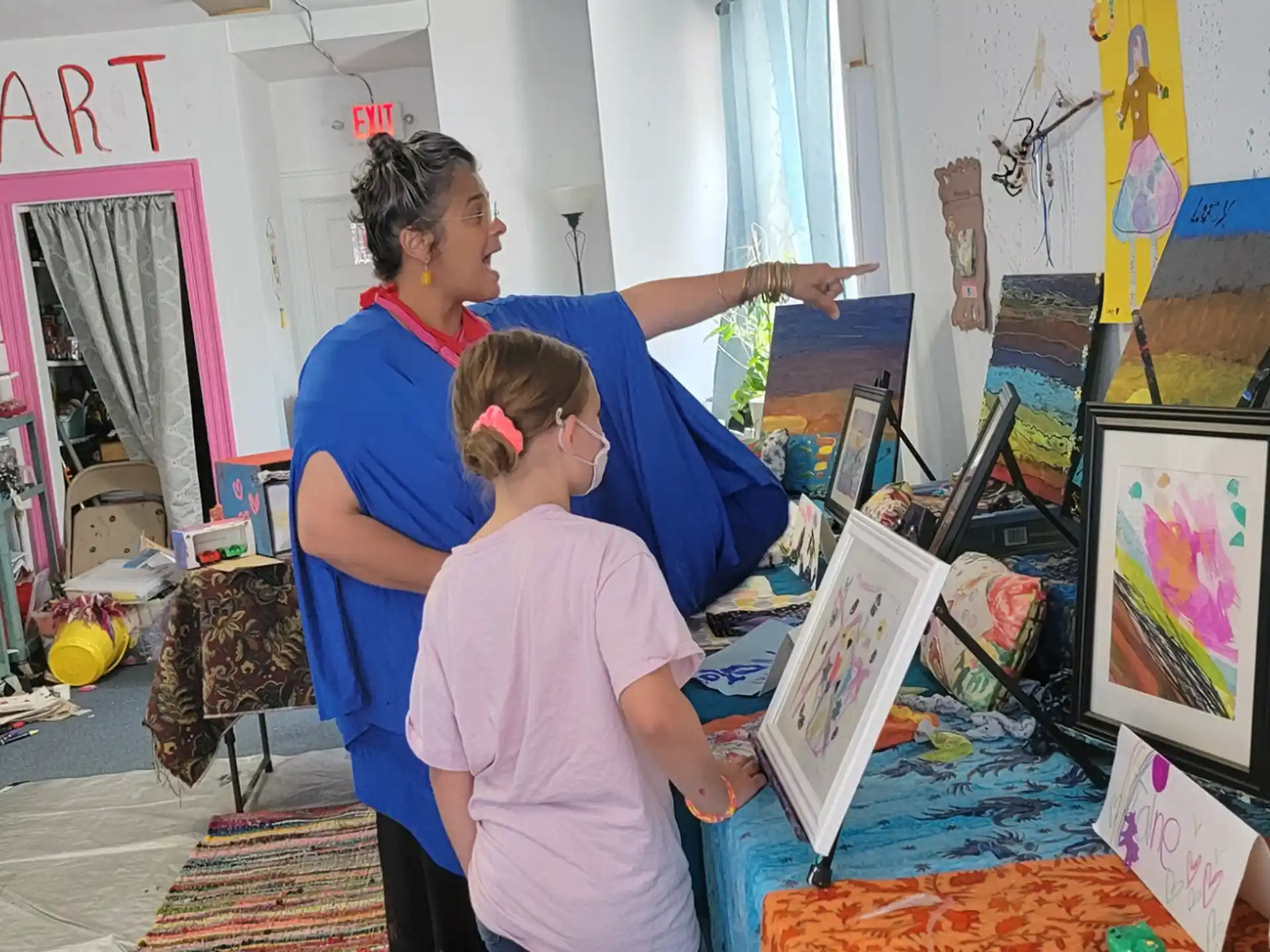 a man showing a young girl something on a picture