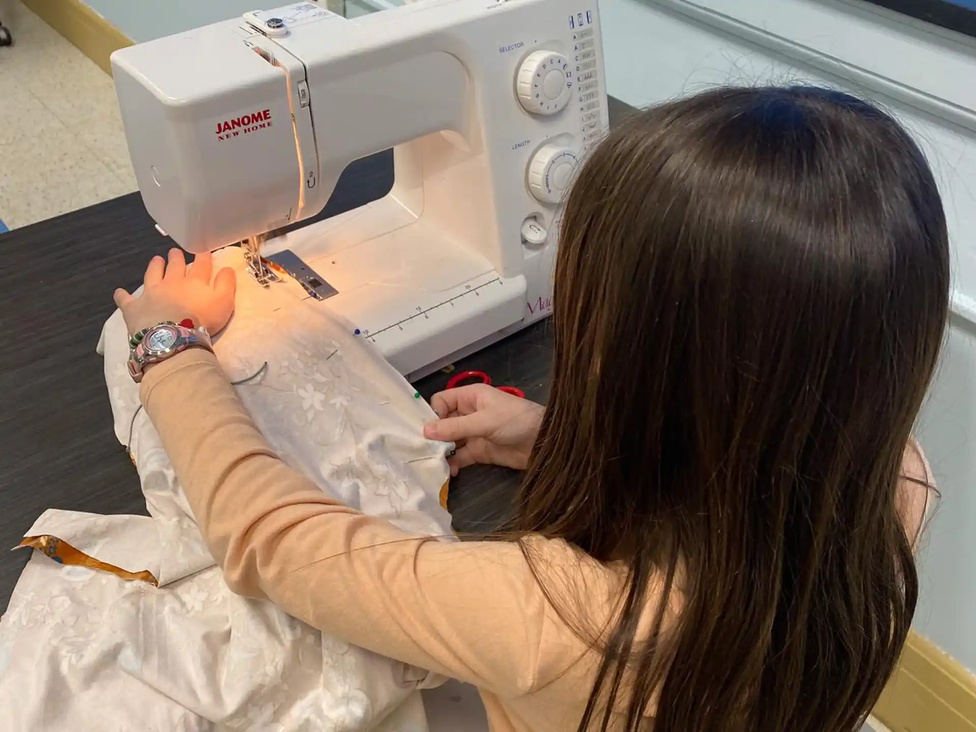 a person using a sewing machine