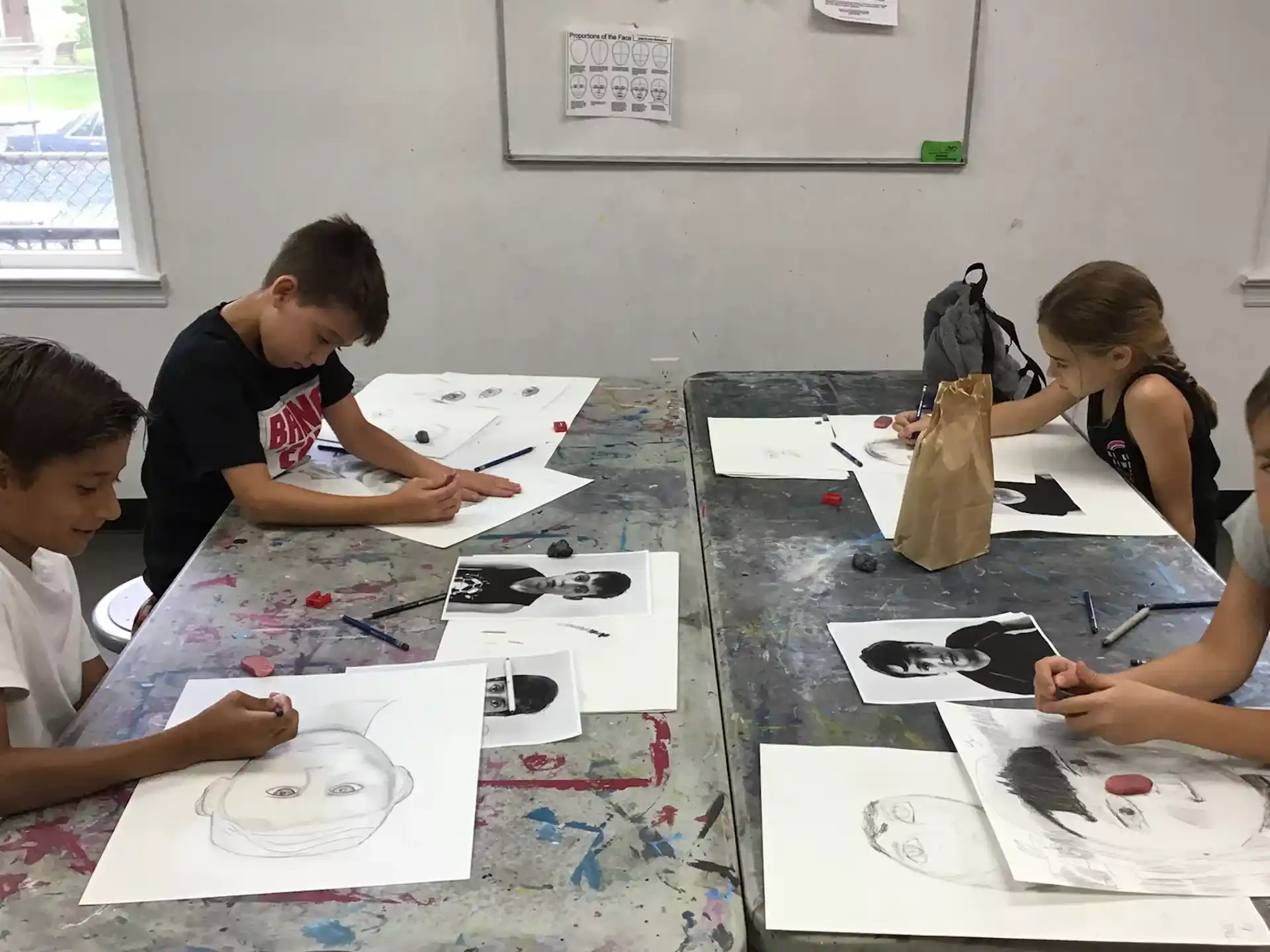 a group of people sitting at a table looking at papers