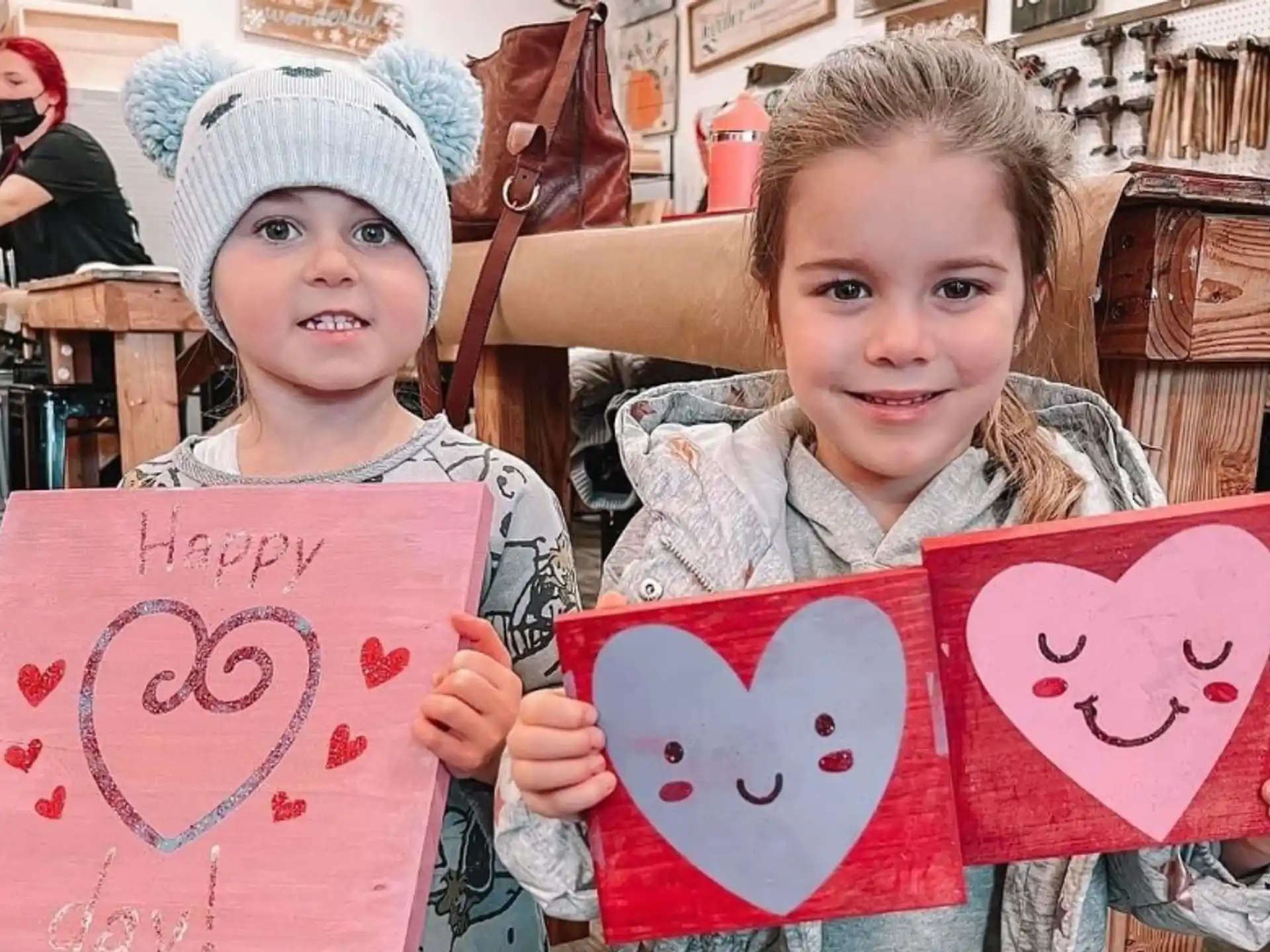 a couple of children holding signs
