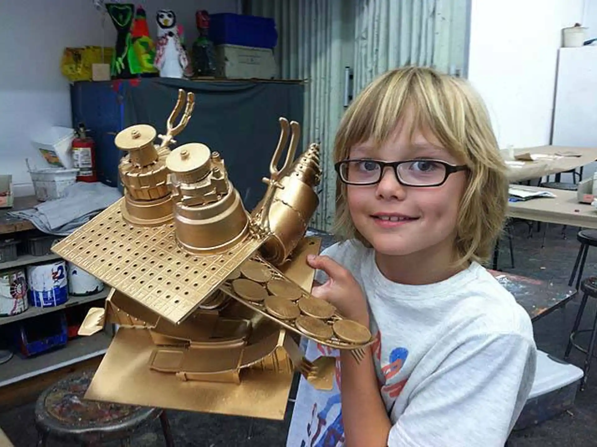 a girl standing next to a robot