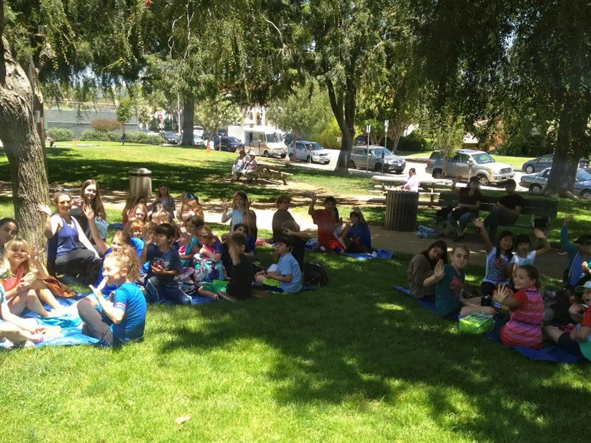 a group of people sitting on the grass