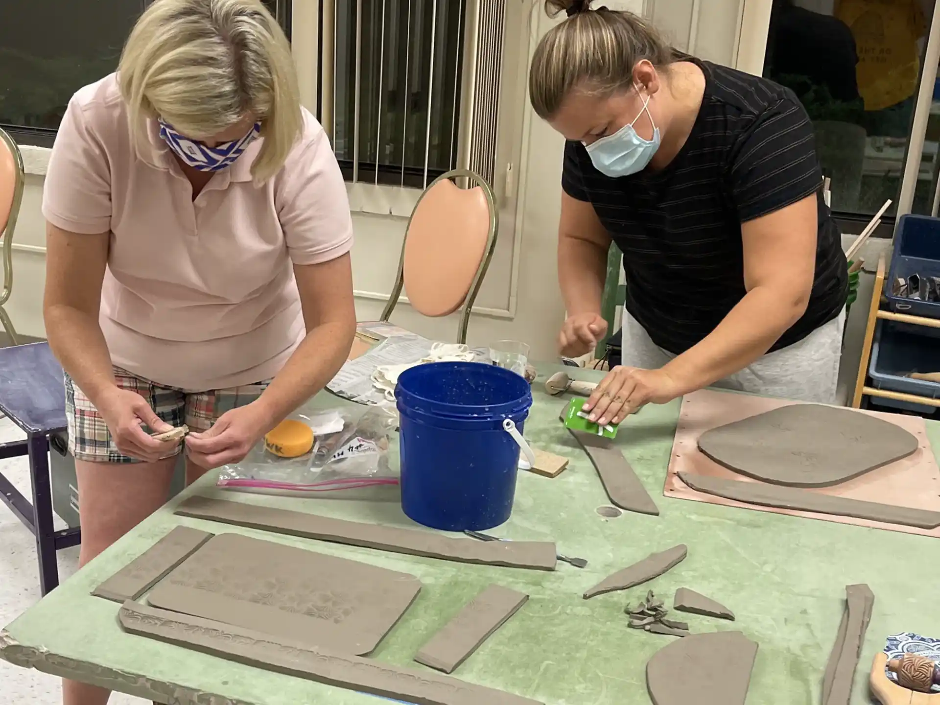 a couple of women painting