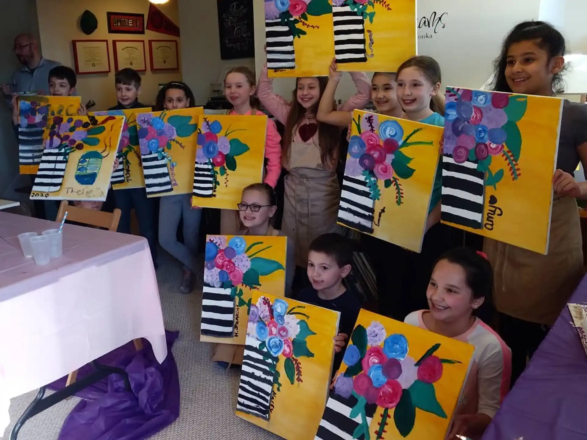 a group of children holding up colorful flags